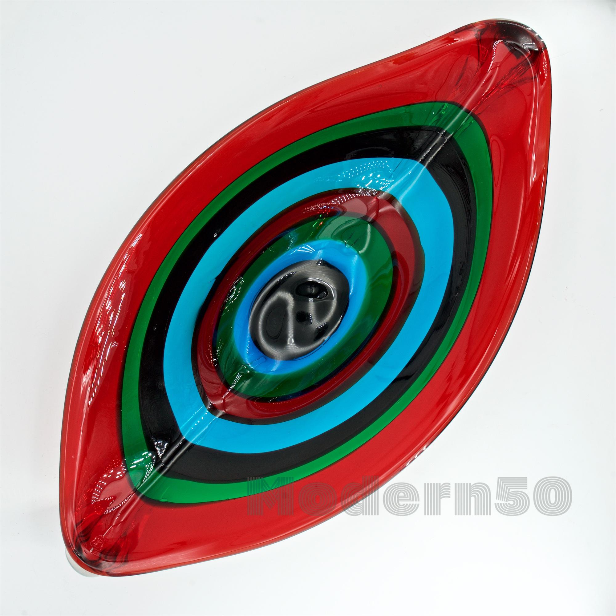 Rare 'A FASCE' centerpiece bowl by Fulvio Bianconi for I.V.R. Mazzega, Murano, Italy, 1959. An eye shaped body, clear glass handles with applied horizontal bands in red, blue, green, purple, turquoise and black. Over 21 inches long, and weighing