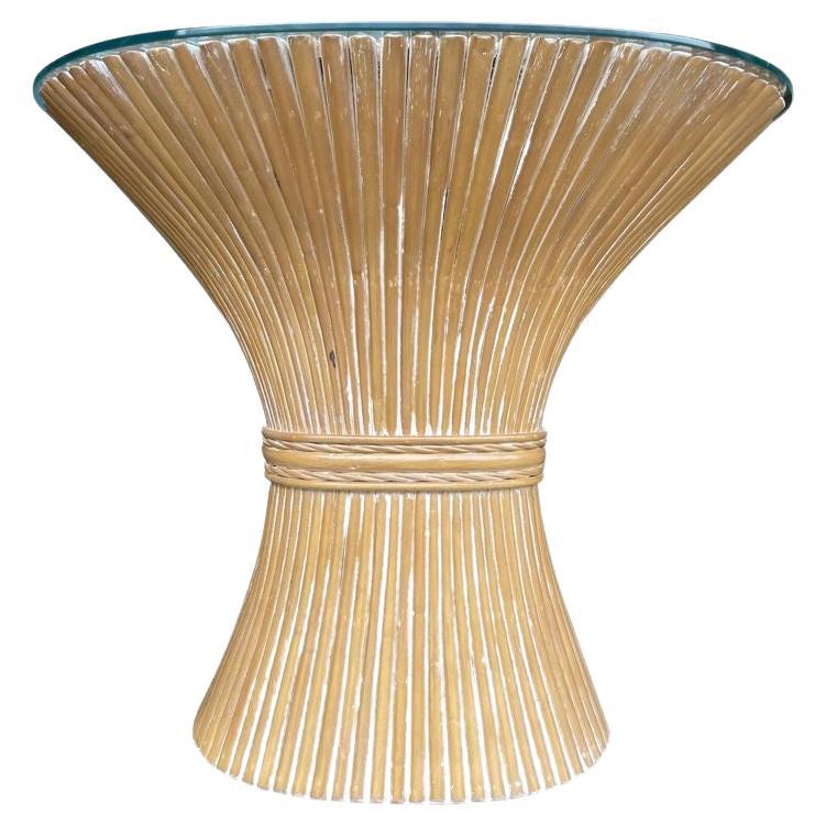 A faux bamboo demilune console table in a wheat sheaf shape, with glass top.