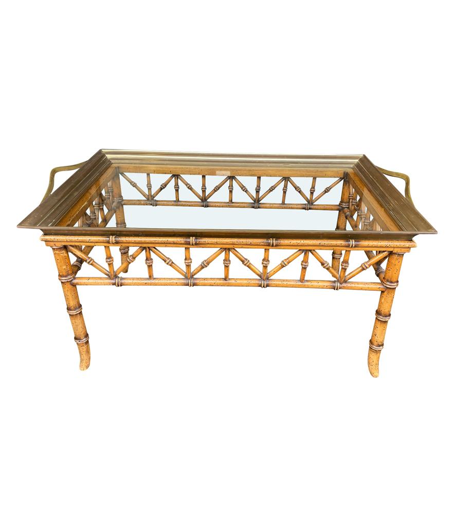 A faux bamboo wooden tray table with solid brass removable glass tray top.