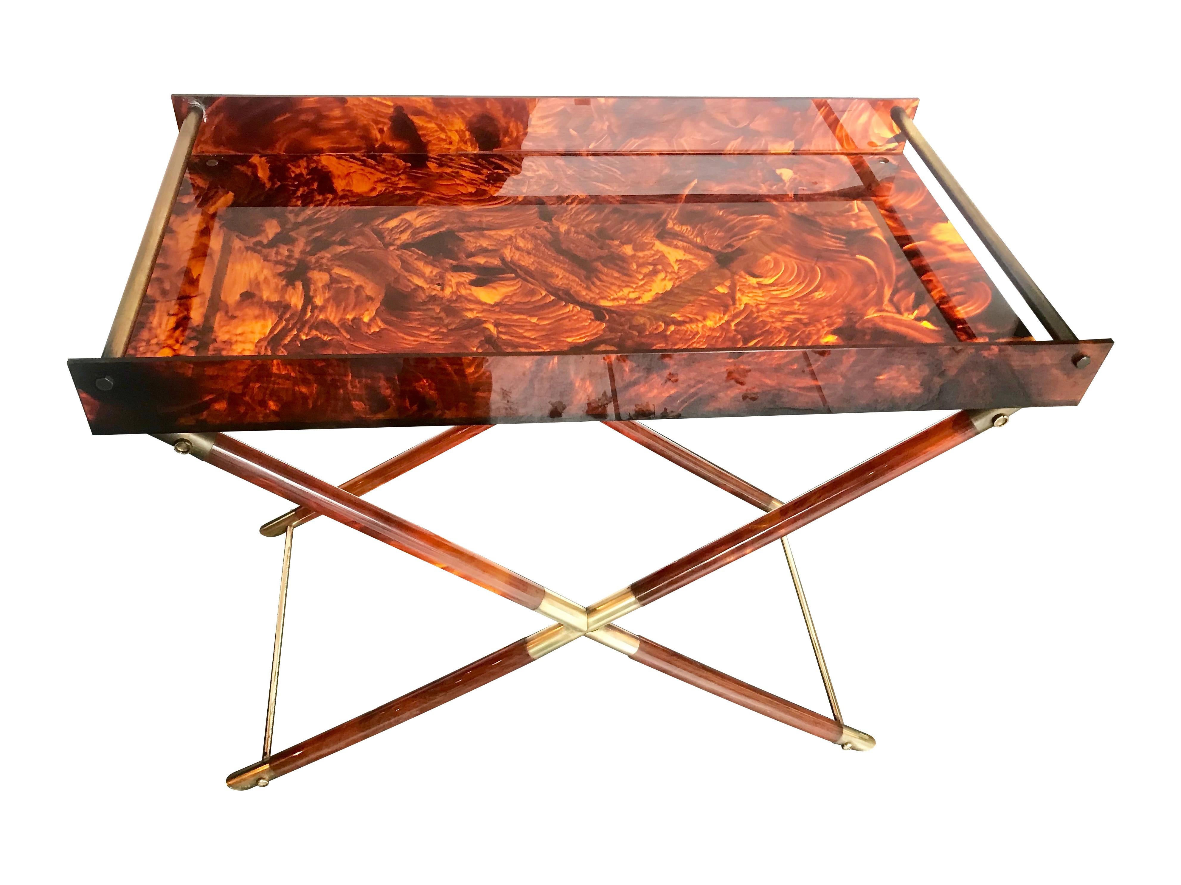 A lovely faux tortoiseshell side table with brass detailing. The top is a tray that lifts off the cross legged base.