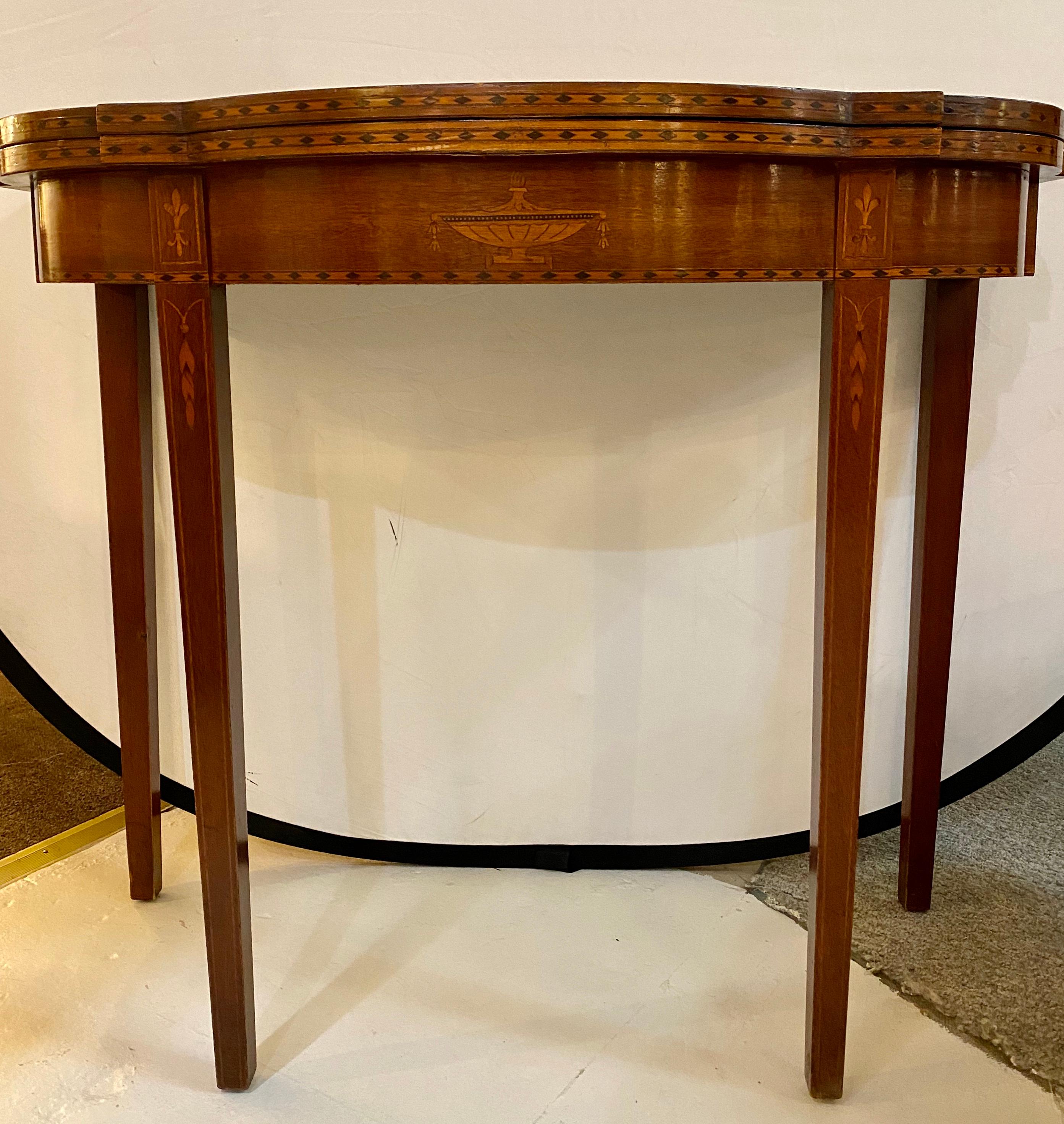 A federal style inlaid flip top card or games table demilune.
Opened table measures: 35.75 inches depth, 36 inches width, and 30.5 inches in height.
