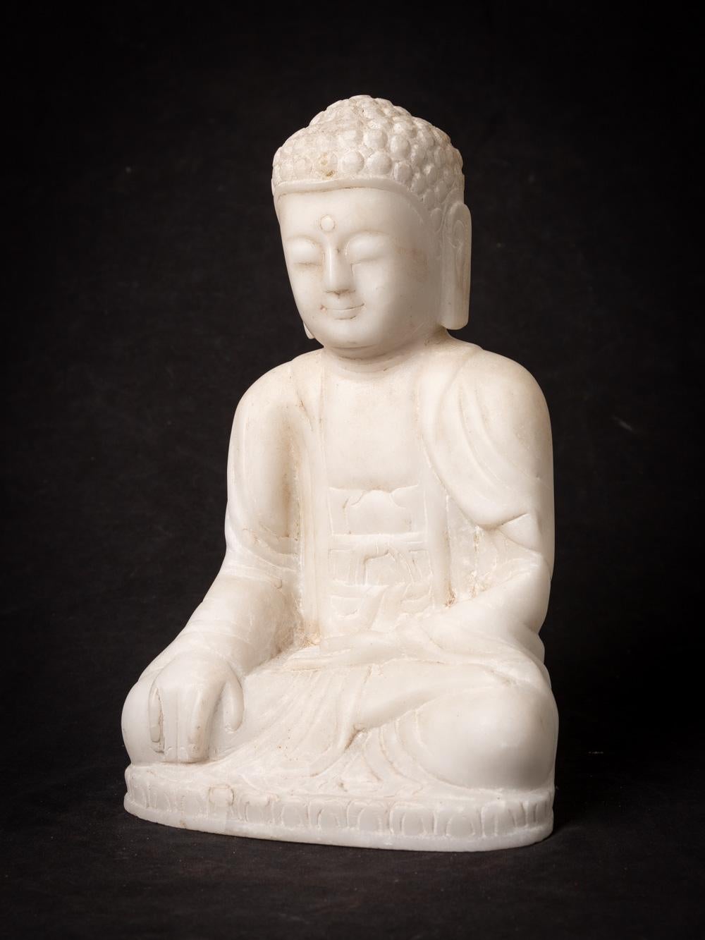 This elegant Marble Buddha statue, portraying the Bhumisparsha mudra, is a work of art that stands at 30.2 cm in height, with dimensions of 19.3 cm in width and 14.8 cm in depth. Carved by hand from a single block of white marble, it represents a