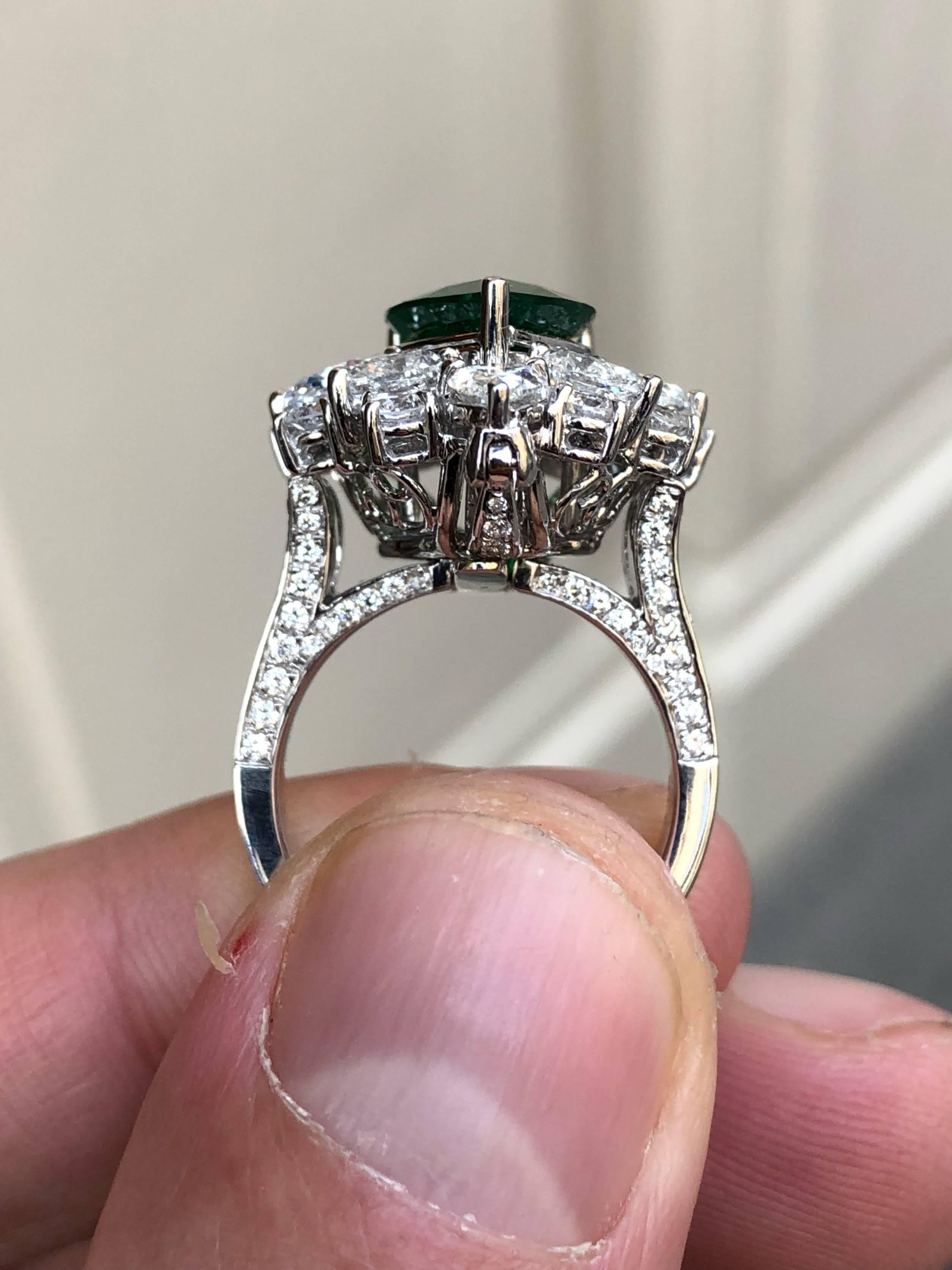 This fine pear cut Muzo emerald ring weighing 3.95 carats is certified by the world renowned Gübelin Gem Lab, Lucerne, Switzerland.  It is encrusted with certified E colour diamonds and the shank is detachable so that the piece may also be worn as a