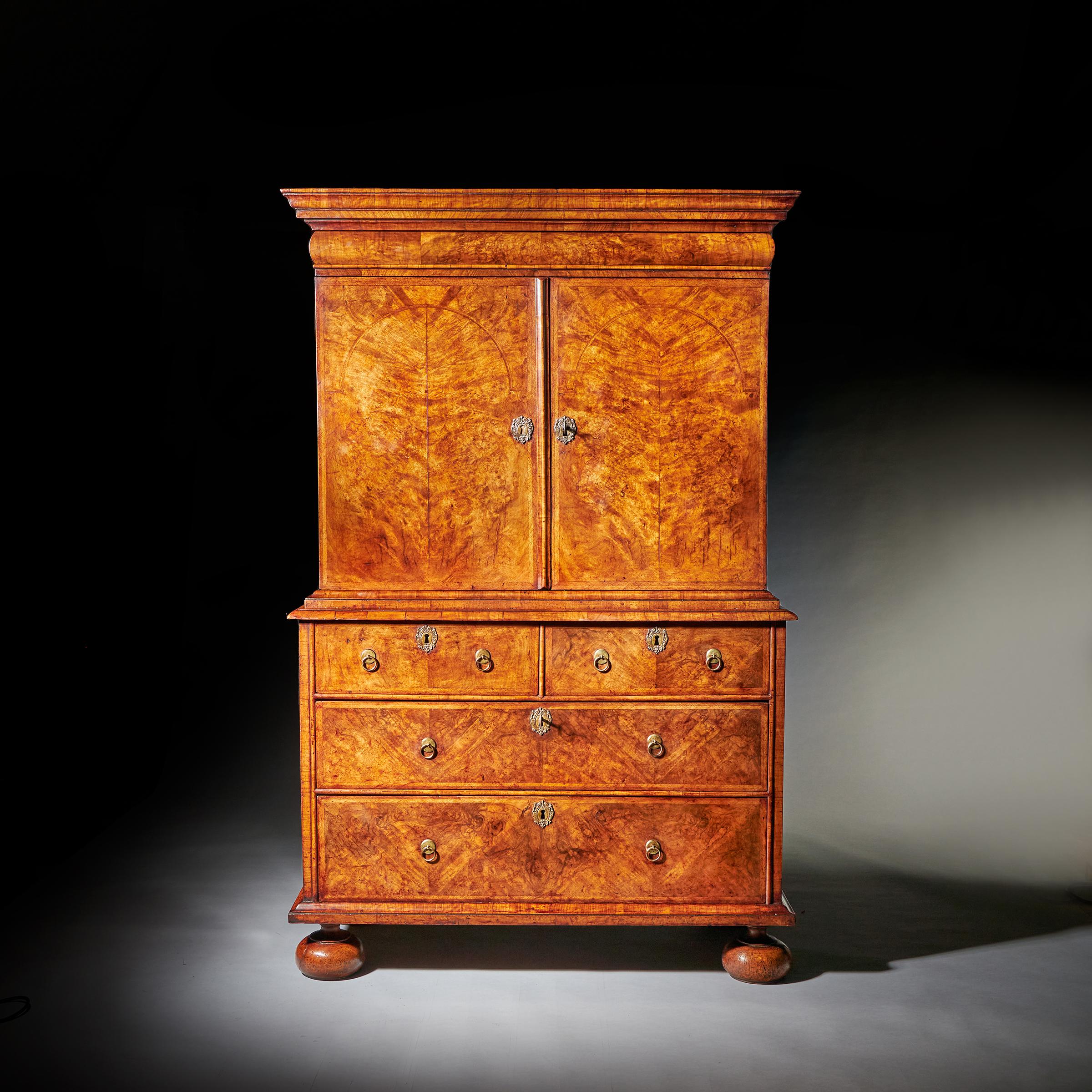 17th century William and Mary burr walnut cabinet on chest, circa 1690. England. Concealing two secret compartments. 

The Cabinet
The cross-grain cornice neatly conceals a full-length hidden drawer known as a cushion drawer and two concealed