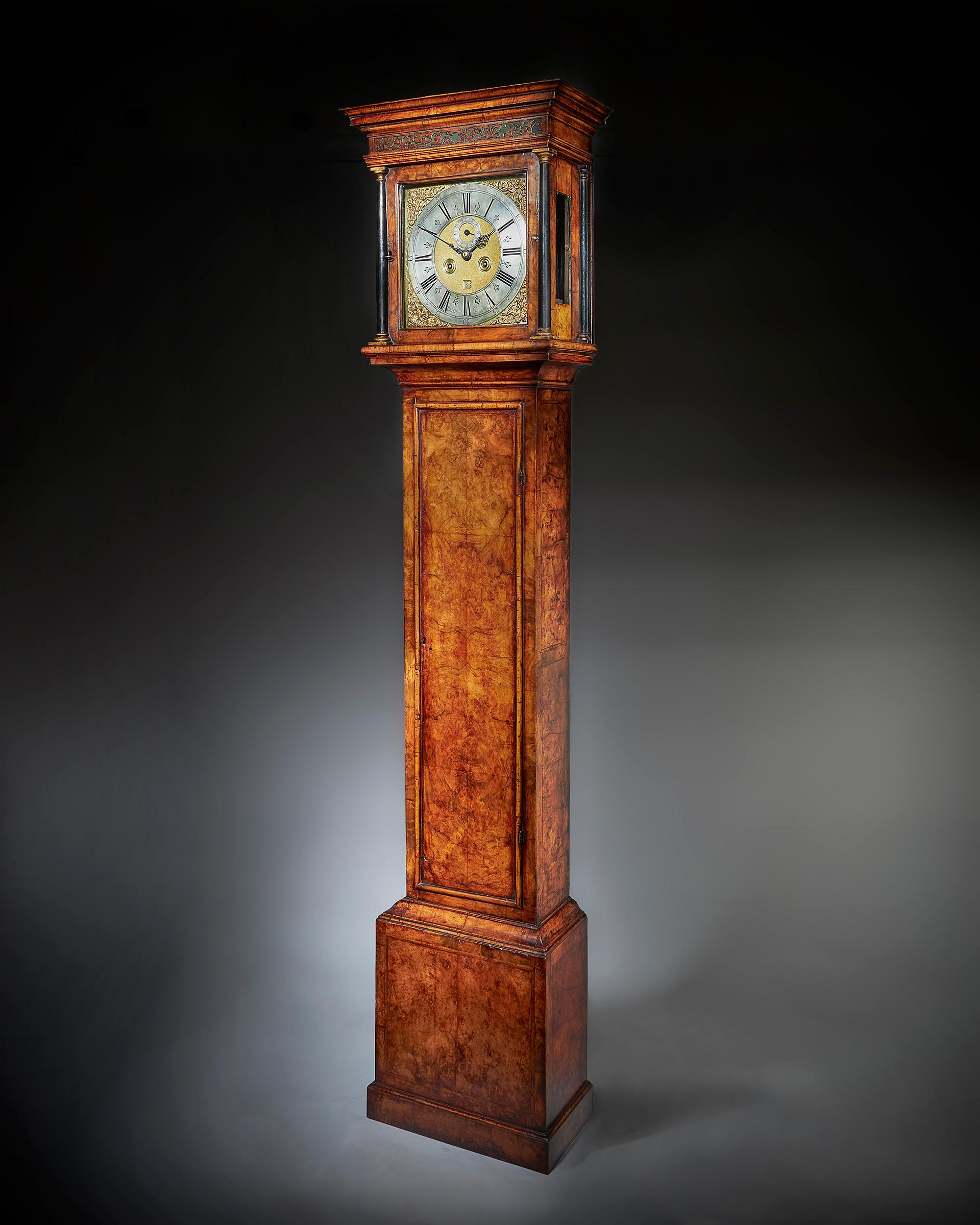 A superb early 18th century eight-day Queen Anne longcase clock by the famous maker Christopher Gould, circa 1705-1710. 

The exquisite burr walnut veneered oak case is of the highest quality, having a square hood and a trunk door framed with