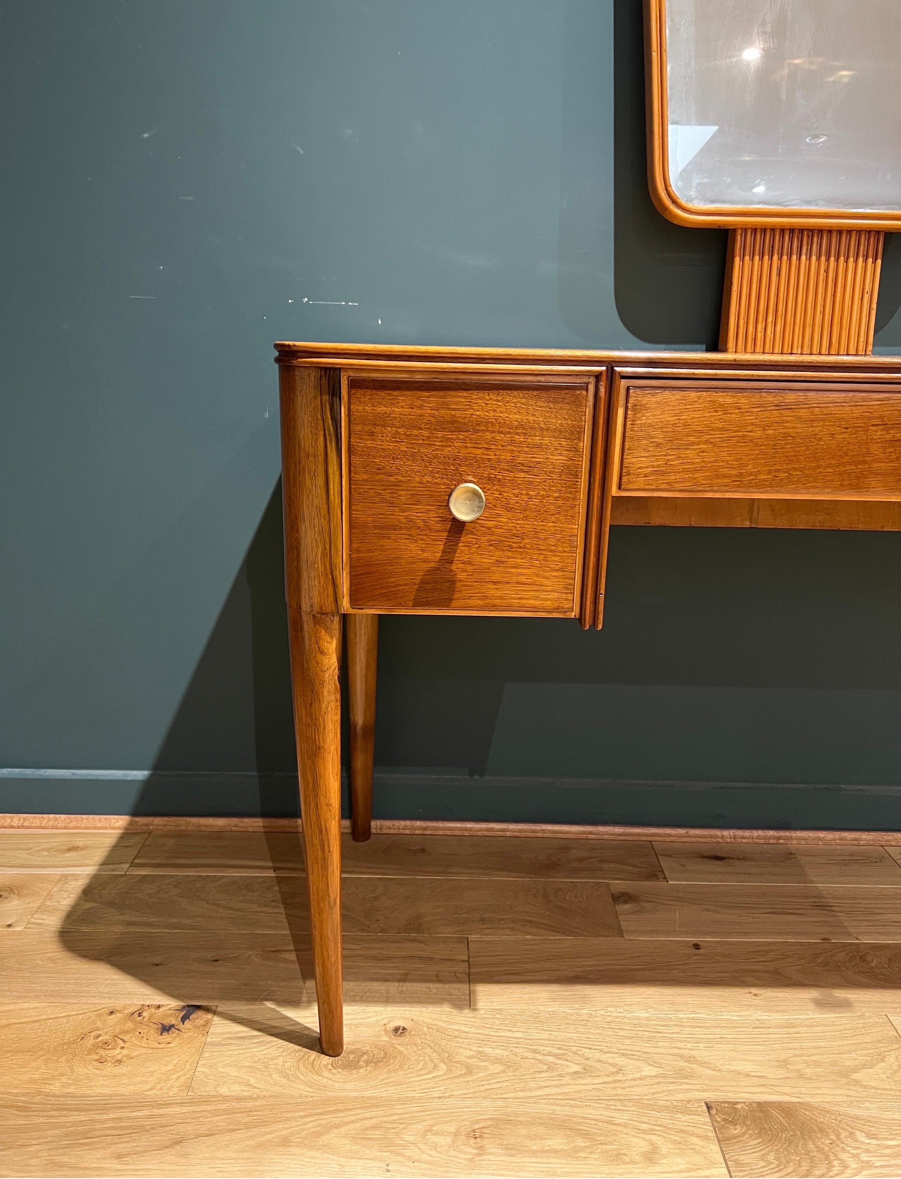 A fine Italian 1950s cherrywood & brass handles dressing table with two flip door drawers and a large framed vanity mirror with reeded wood base centred above a spacious middle drawer. 
Designed by Ulrich. 
The mirror is detachable to reduce