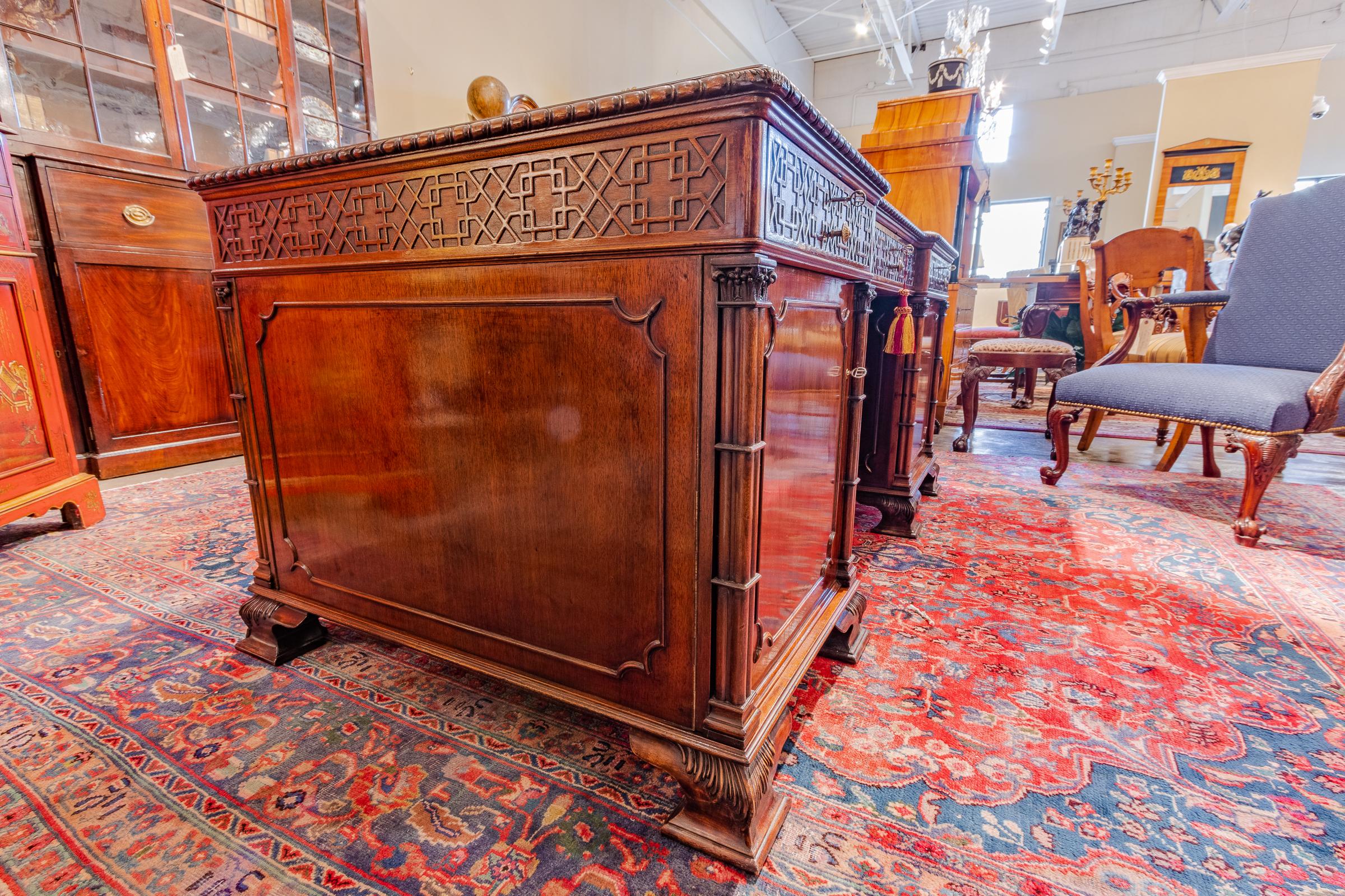 A fine 19th century English Chinese Chippendale mahogany hand carved partners desk original leather top.