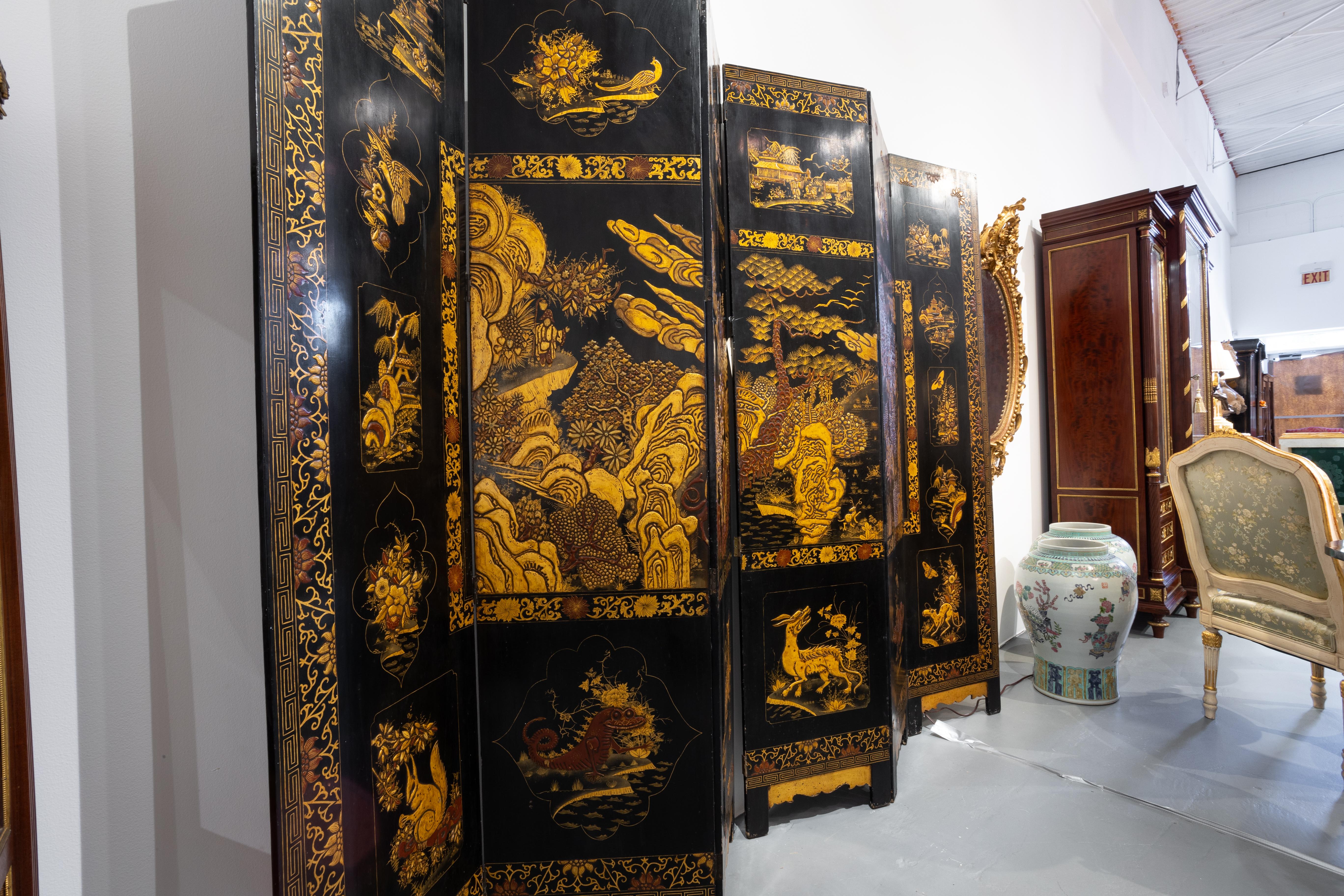 A fine 19th century English black lacquered Chinoiserie decorated 6 panel screen. Greek key design with scenes of figures and animals. Raised detail.