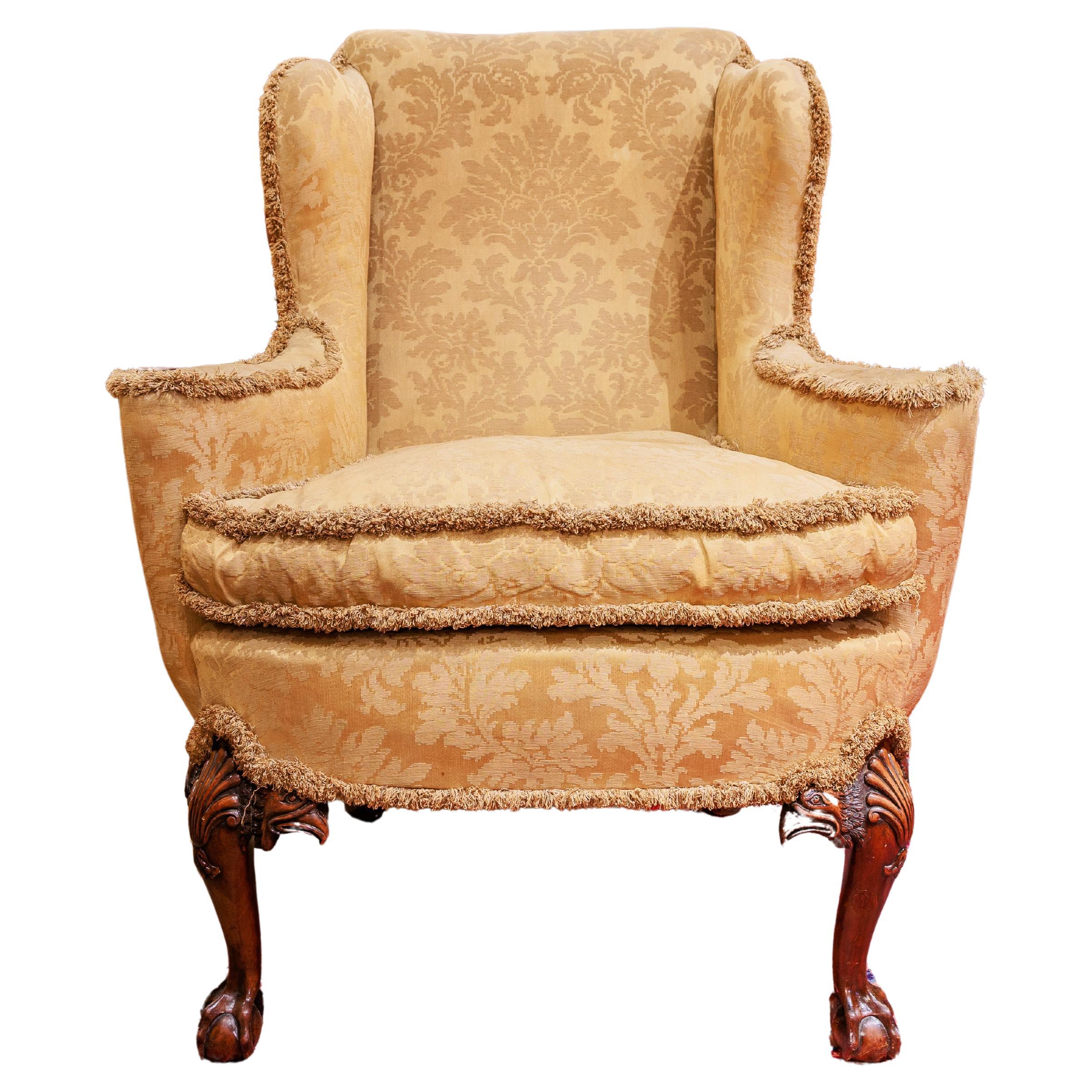 A fine 19th c  English  walnut wingchair. Eagles heads with ball & claw feet For Sale