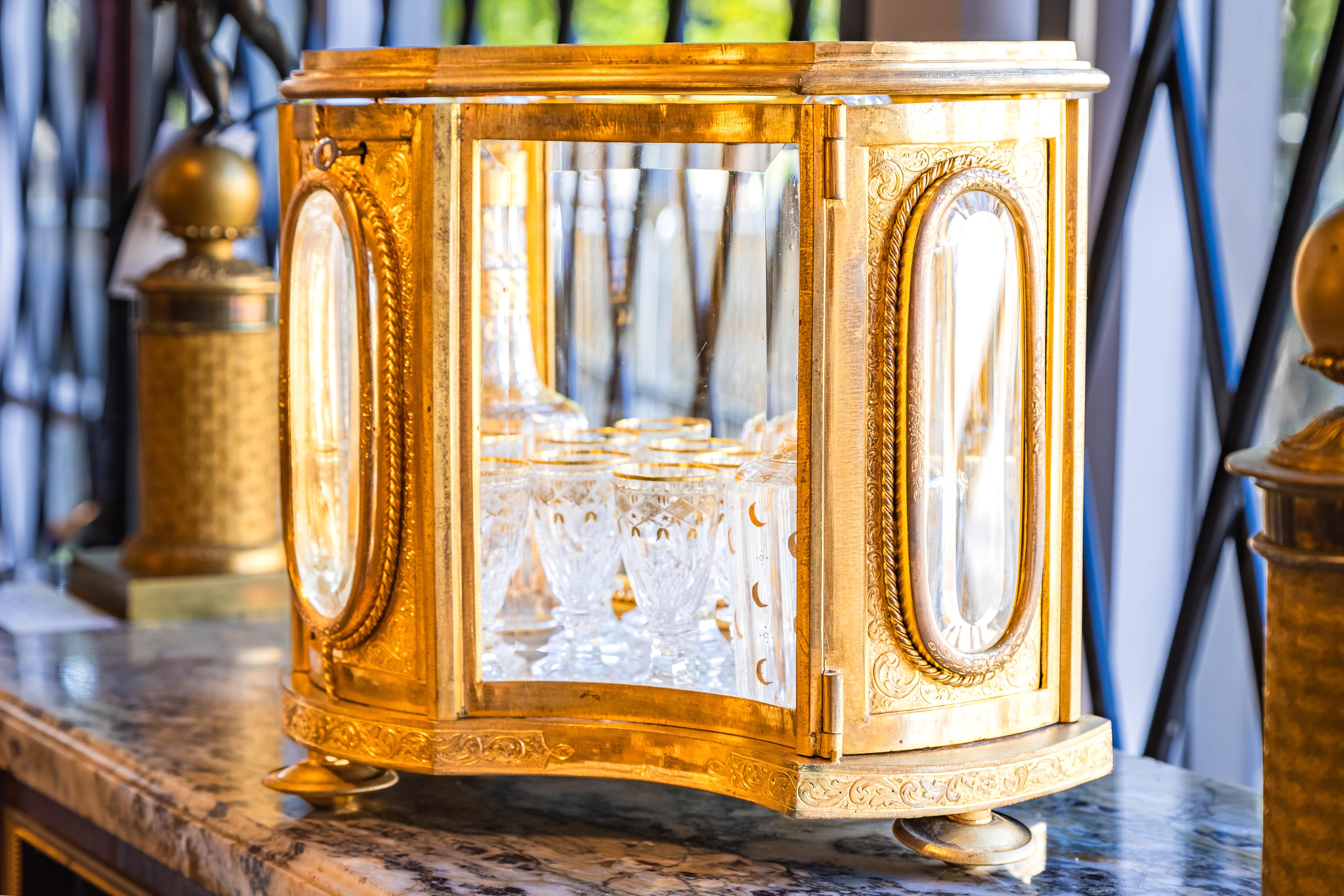 A very fine 19th century French Liquor set with glass and gilt bronze construction. Fine cut crystal decanters and liquor glasses with 24 qt gold trim. All original and in excellent condition .No damage 