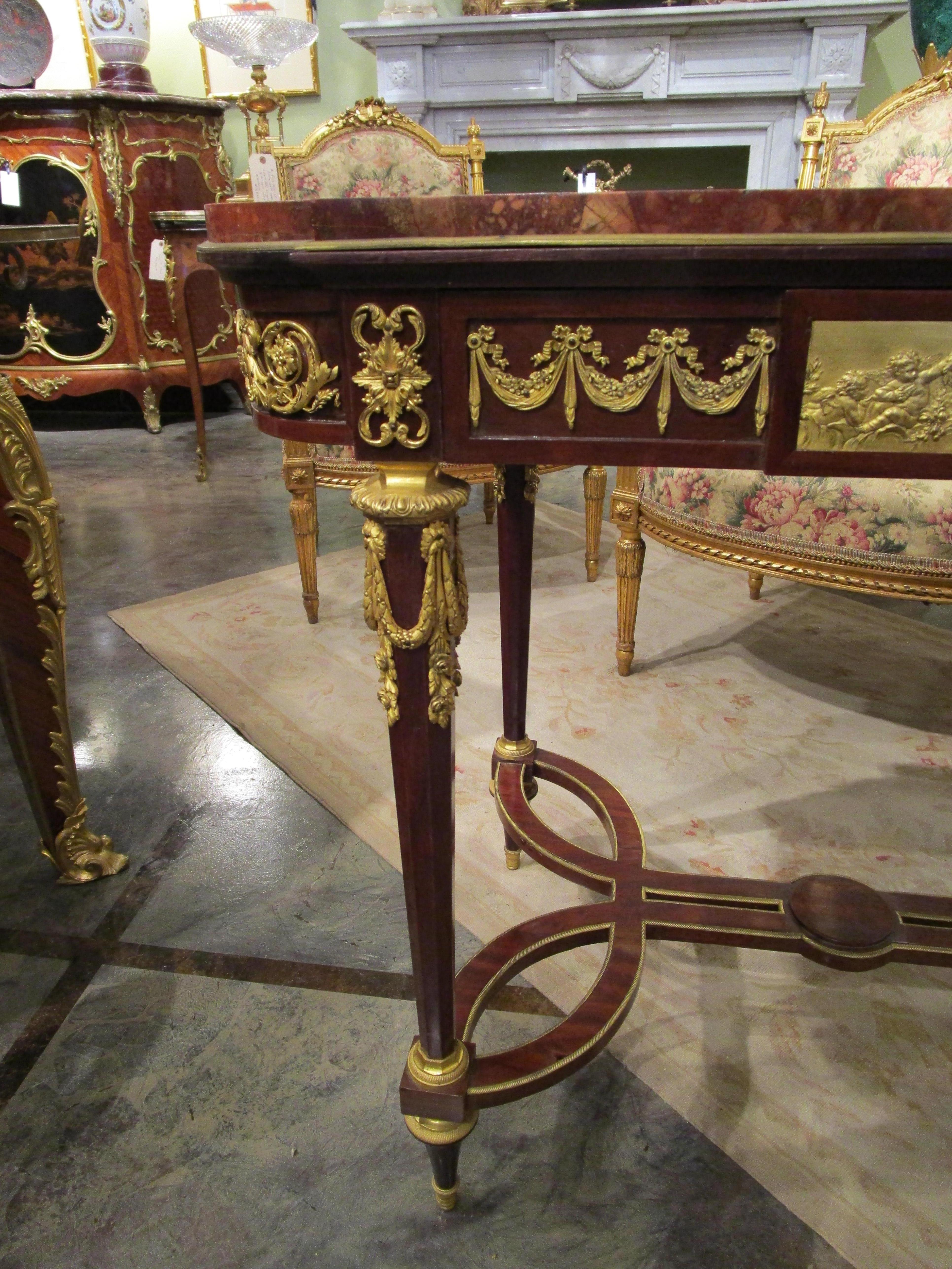 Gilt A fine 19th c French Louis XVI mahogany and gilt bronze mounted centertable