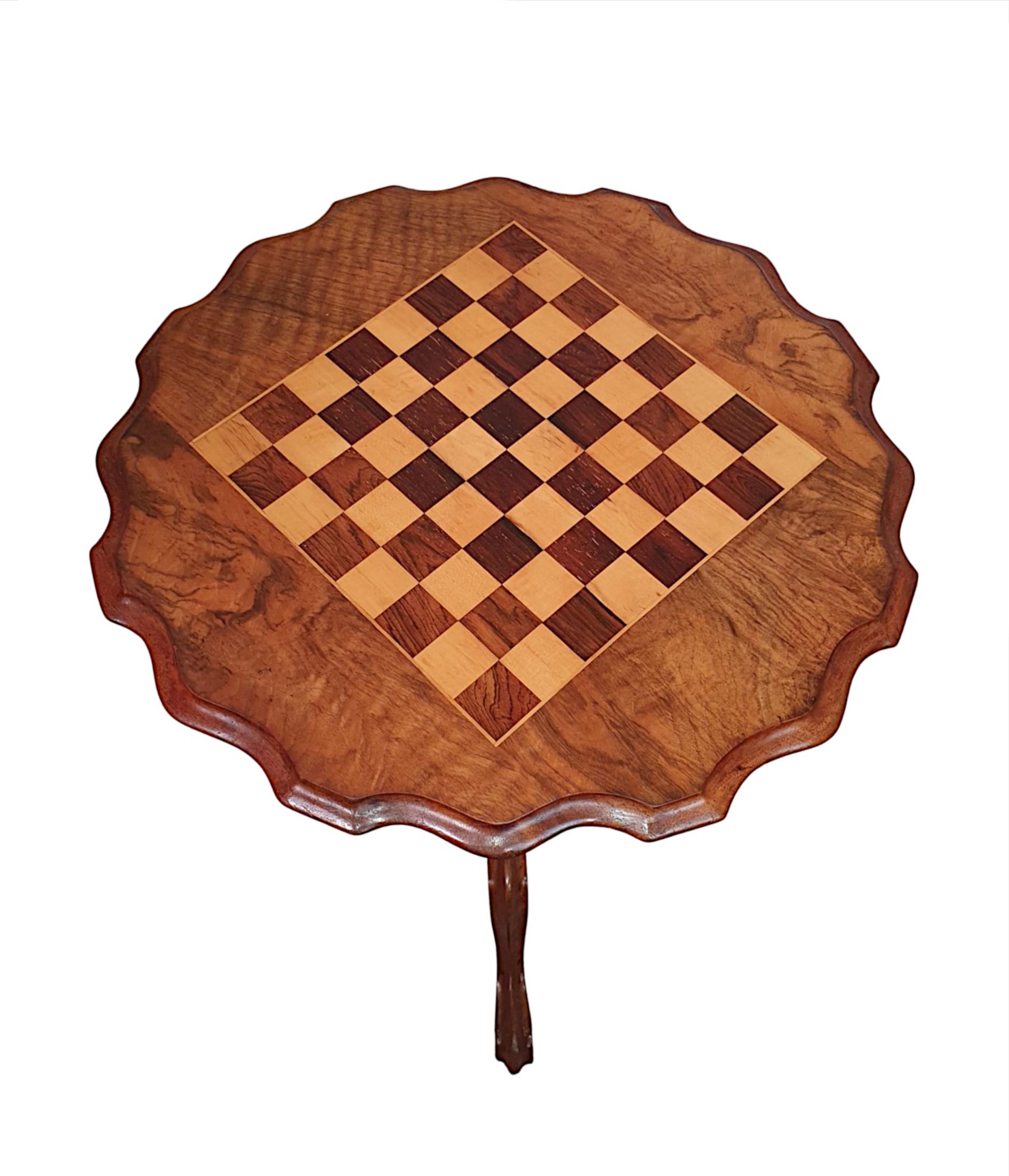 A fine 19th century burr walnut and fruitwood chess table. The shaped and moulded top of circular form with striking marquetry inlaid chess game squares, raised over turned baluster column with beautifully carved detail supported on triform cabriole