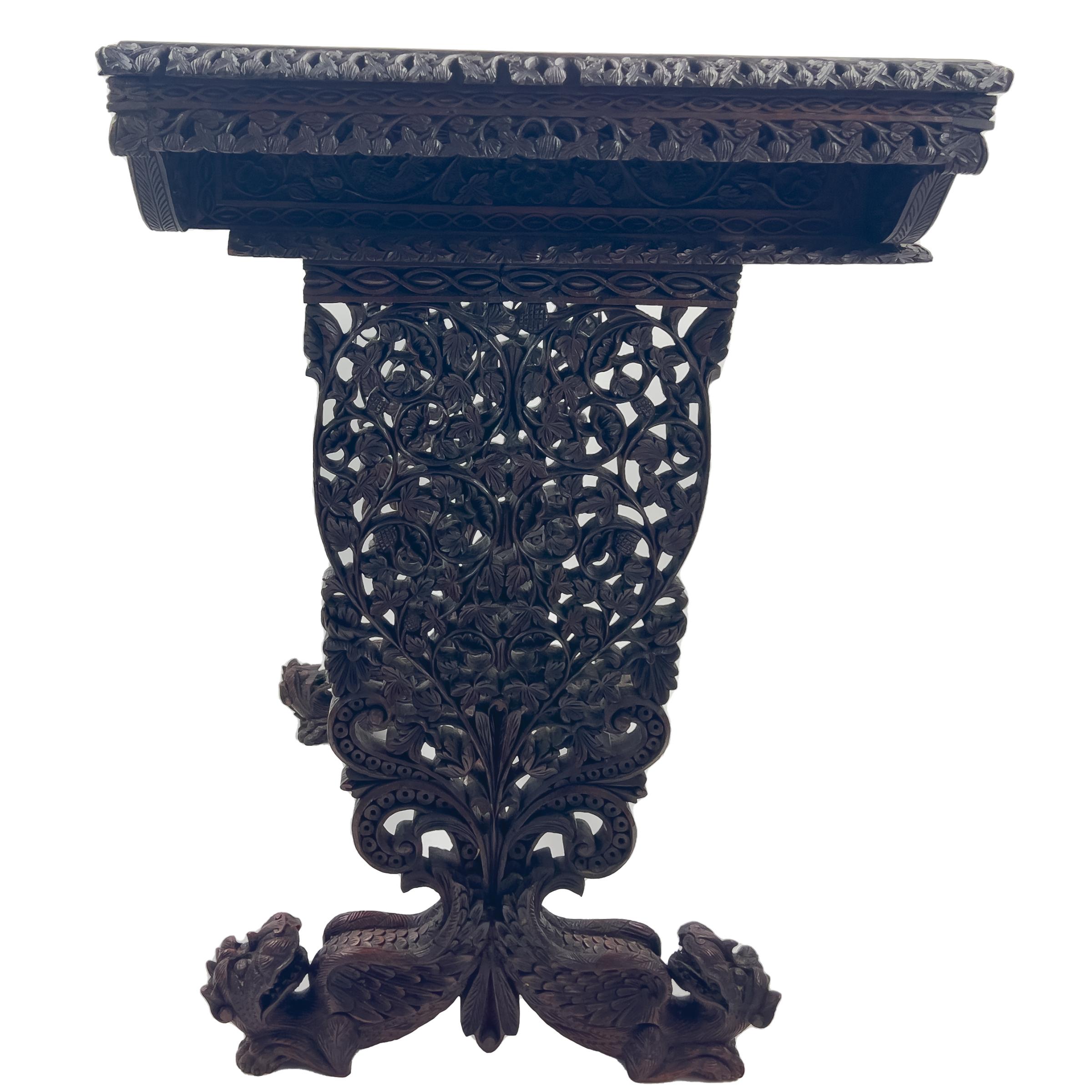 19th century anglo-Indian work table, the carved frieze with single drawer, raised on carved and pierced supports and mythical beast feet, joined by stretcher.
