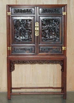 A FINE 19TH CENTURY CARVED HUANGHUALI TWO DOOR CABiNET ON STAND QING DYNASTY