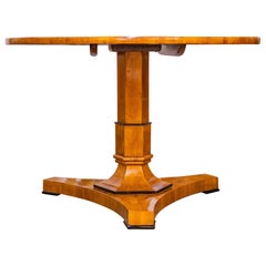 A fine 19th century Cherrywood Biedermeier centertable with ebonized details