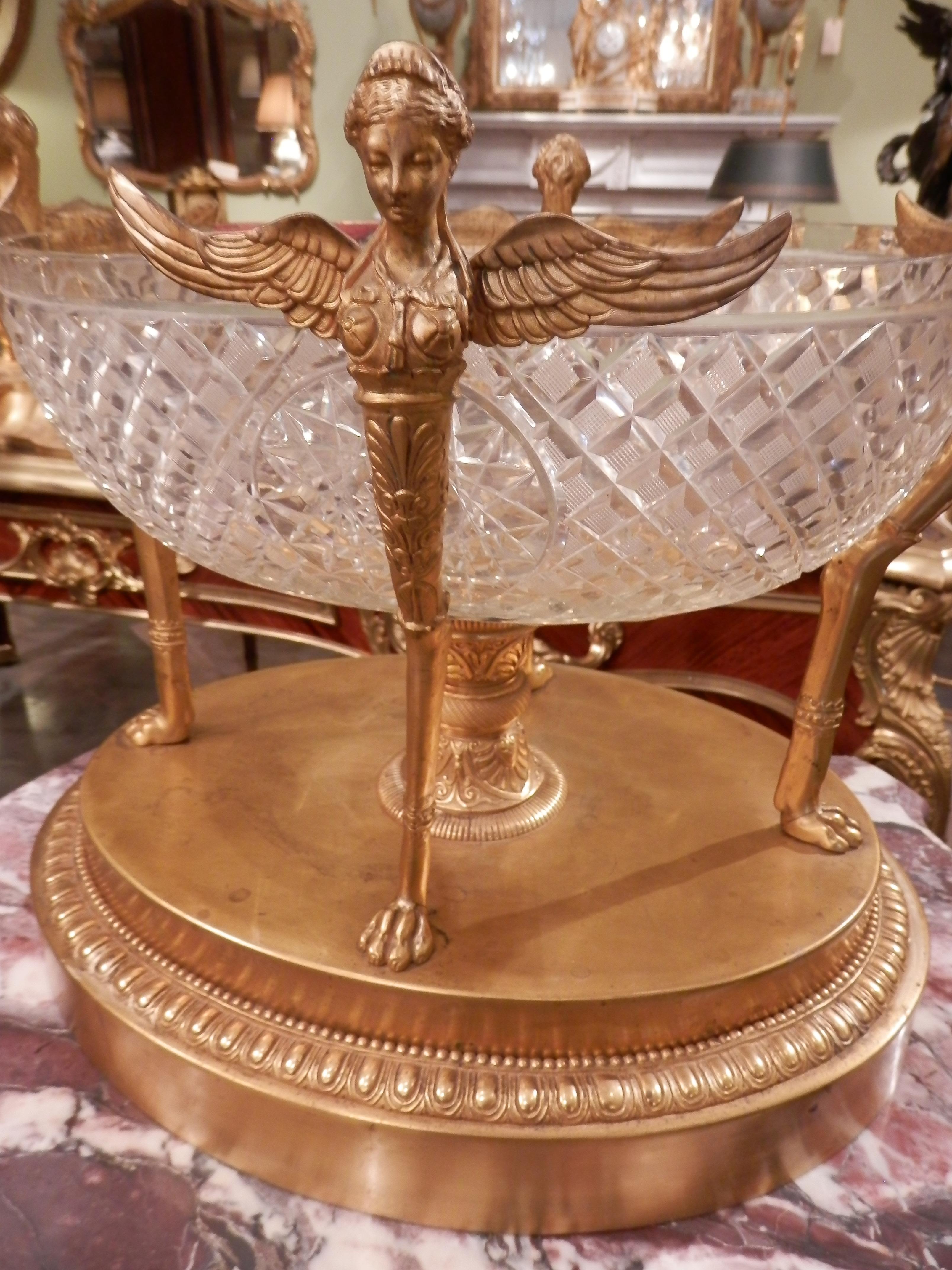 A finely detailed 19th century Empire cut crystal and gilt bronze large centerpiece . Finely chased female winged caryatids