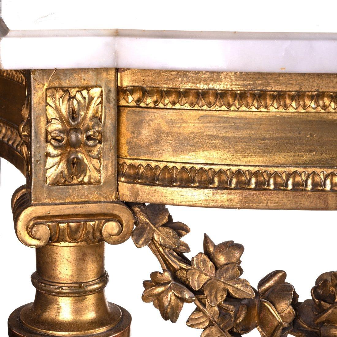 A fine and beautiful 19th century Louis XVI gilt carved console with the original Carrara marble top.