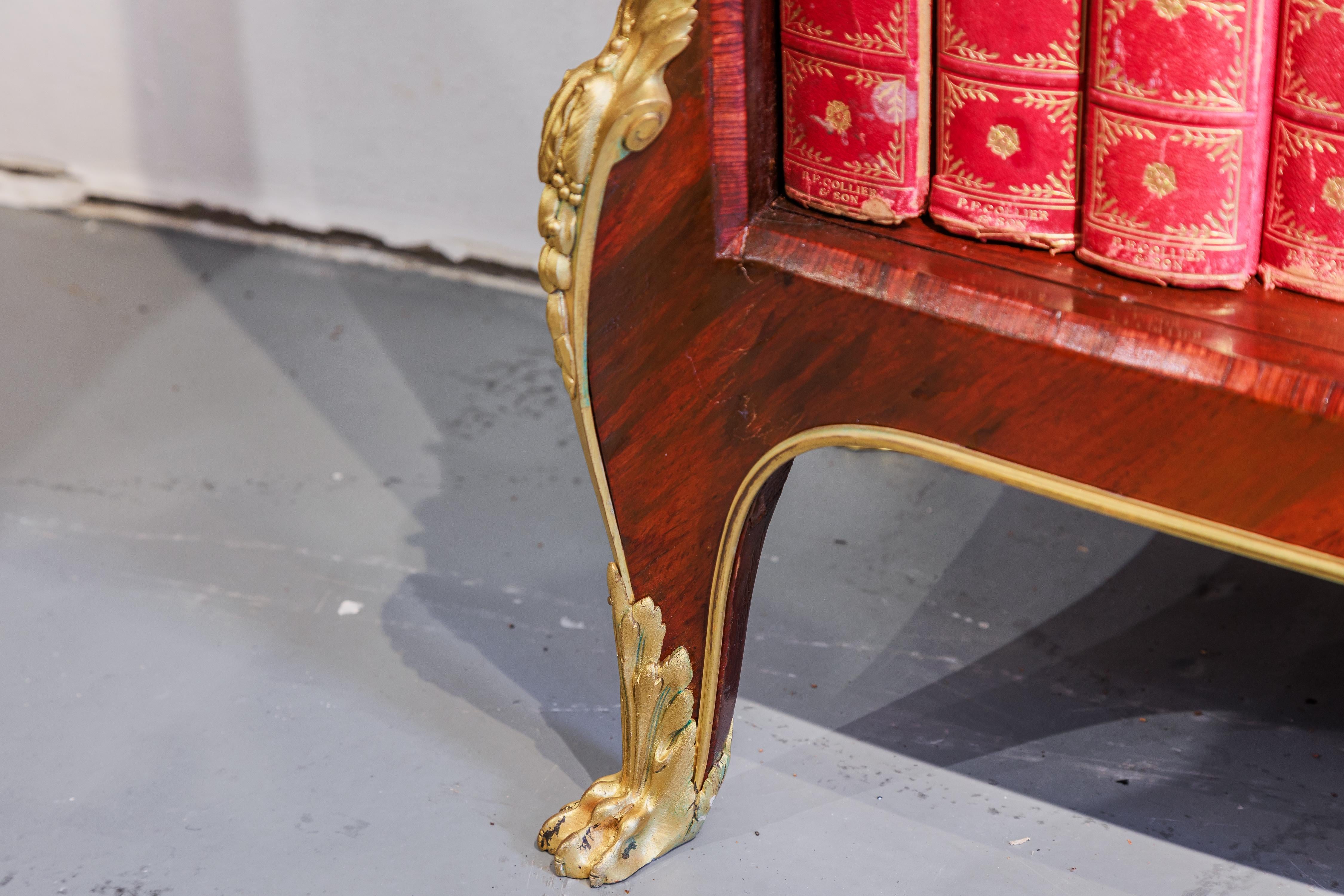 A fine 19th century French Louis XVI mahogany and very fine gilt bronze mounted marble top bookcase . Attributed to F Linke 