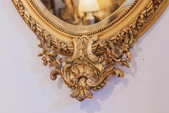 A fine 19th century French Louis XVI oval carved and gilt mirror