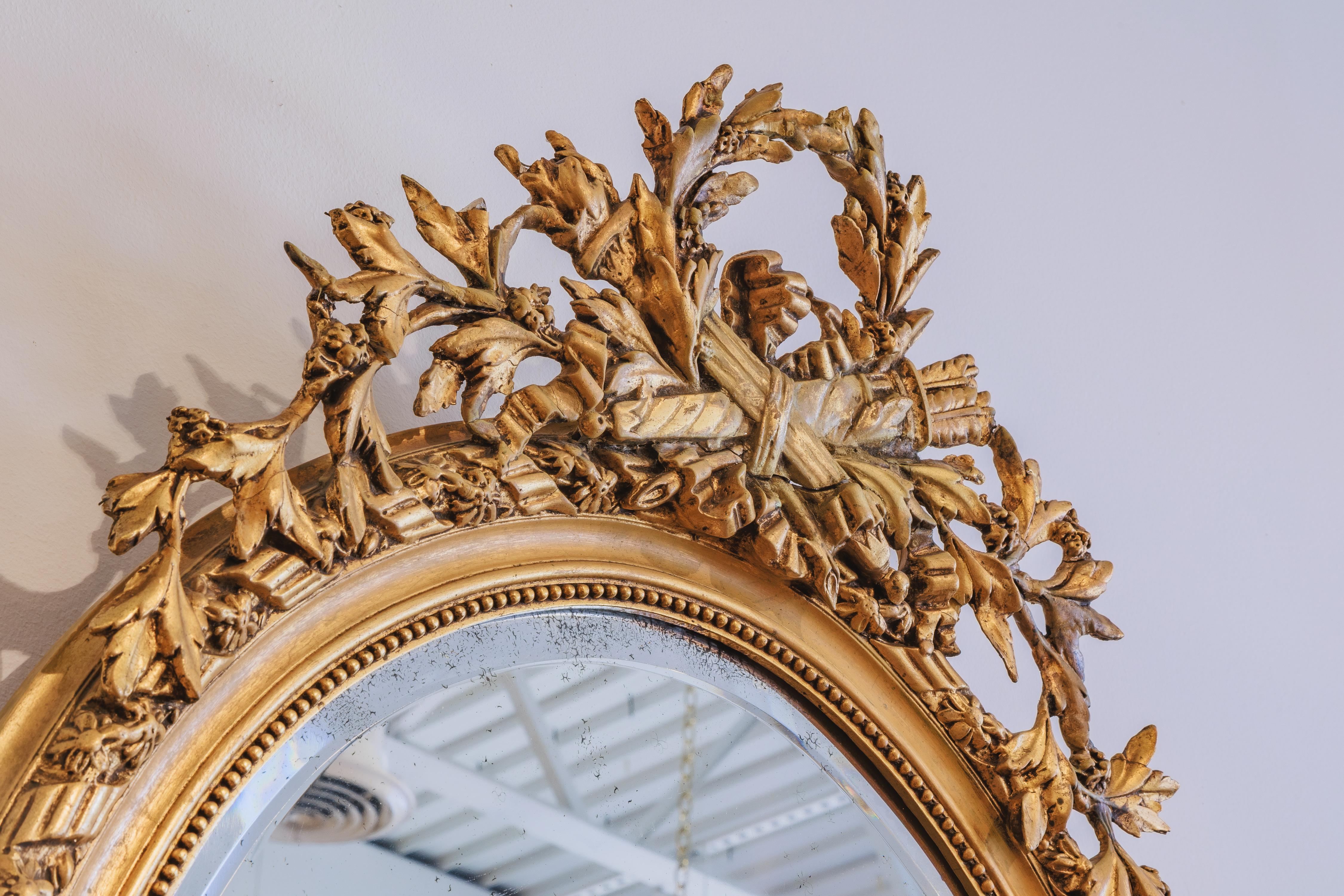 A fine 19th century French Louis XVI oval carved and gilt mirror (Französisch) im Angebot