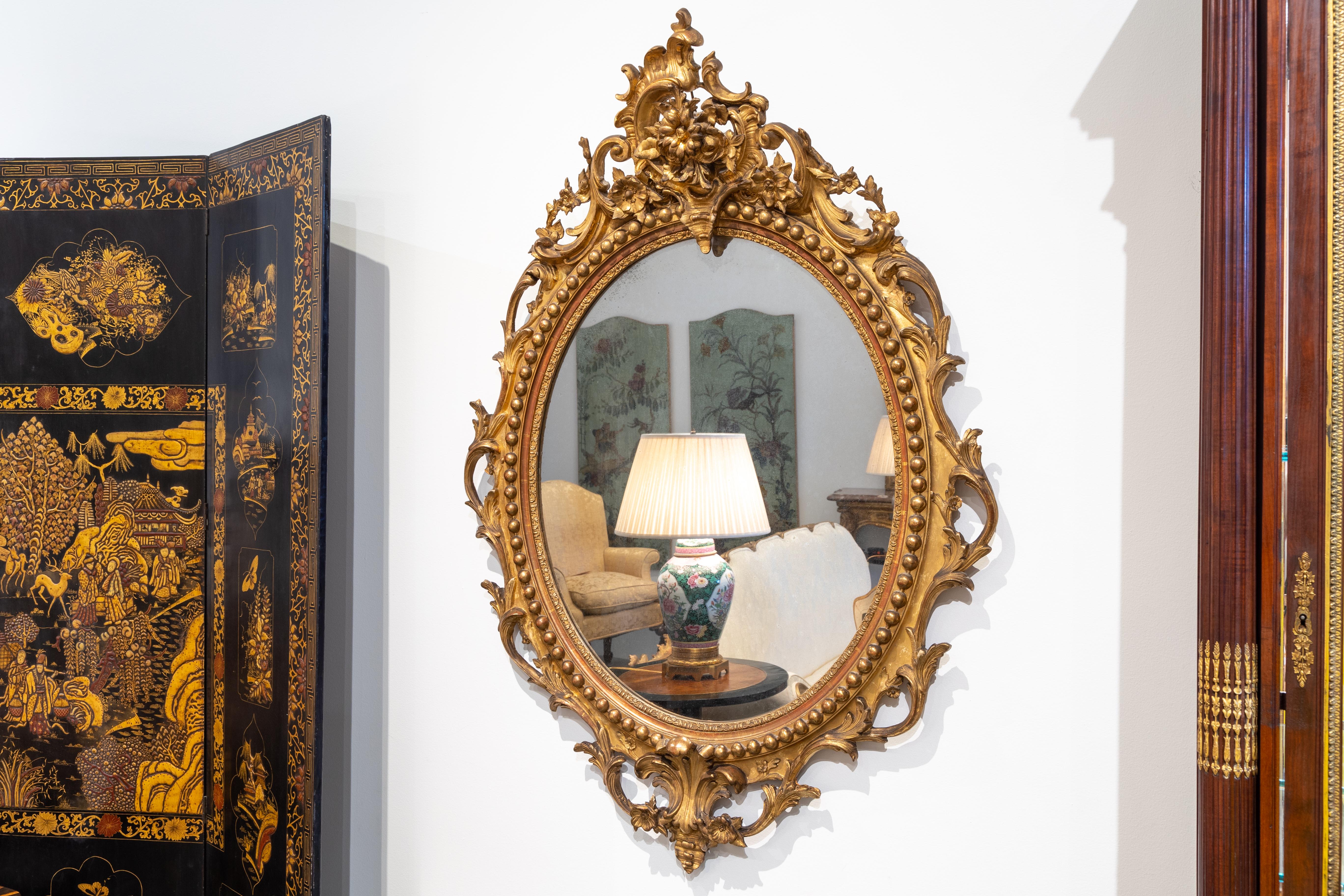 A fine French 19th century hand carved and gilt oval Louis XVI mirror. Beautiful carving and detail. All original.