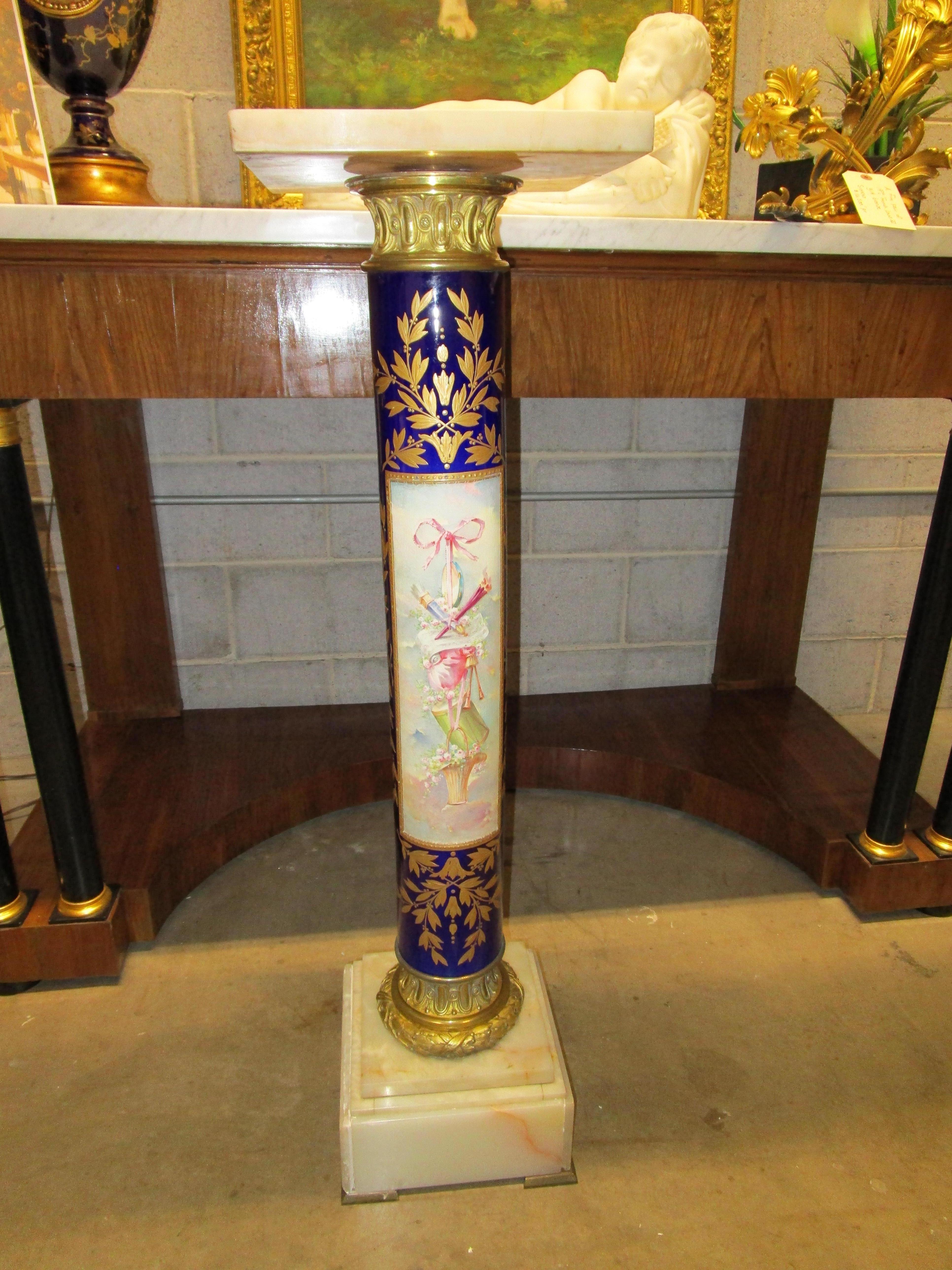 A fine and beautiful 19th century French Sevre's cobalt blue pedestal with a hand painted scene . Fine gilt bronze mounts and a onyx base and top.