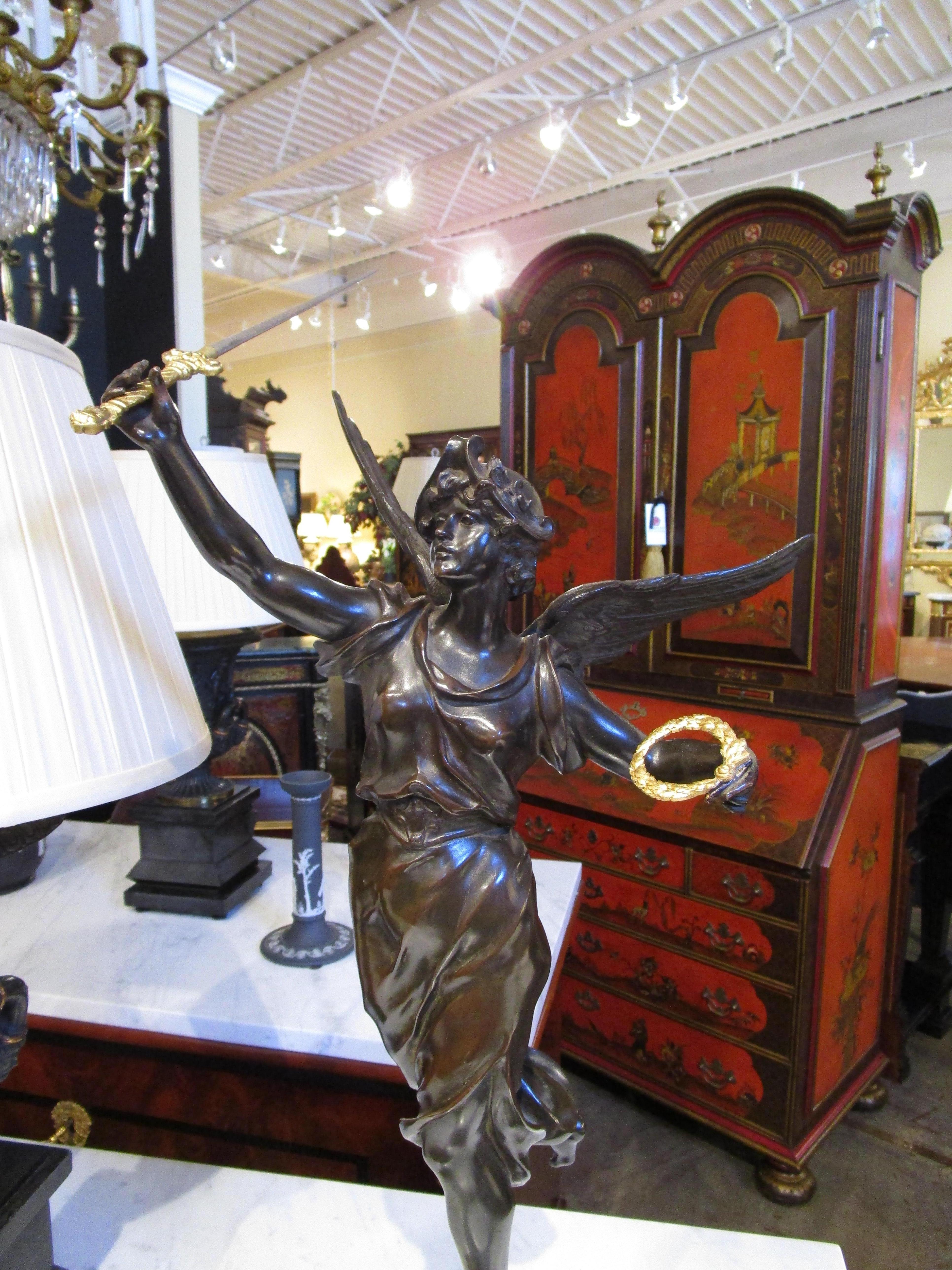 A fine 19th century French bronze depicting Victory. Signed with beautiful details and parcel gilt sword and wreath.