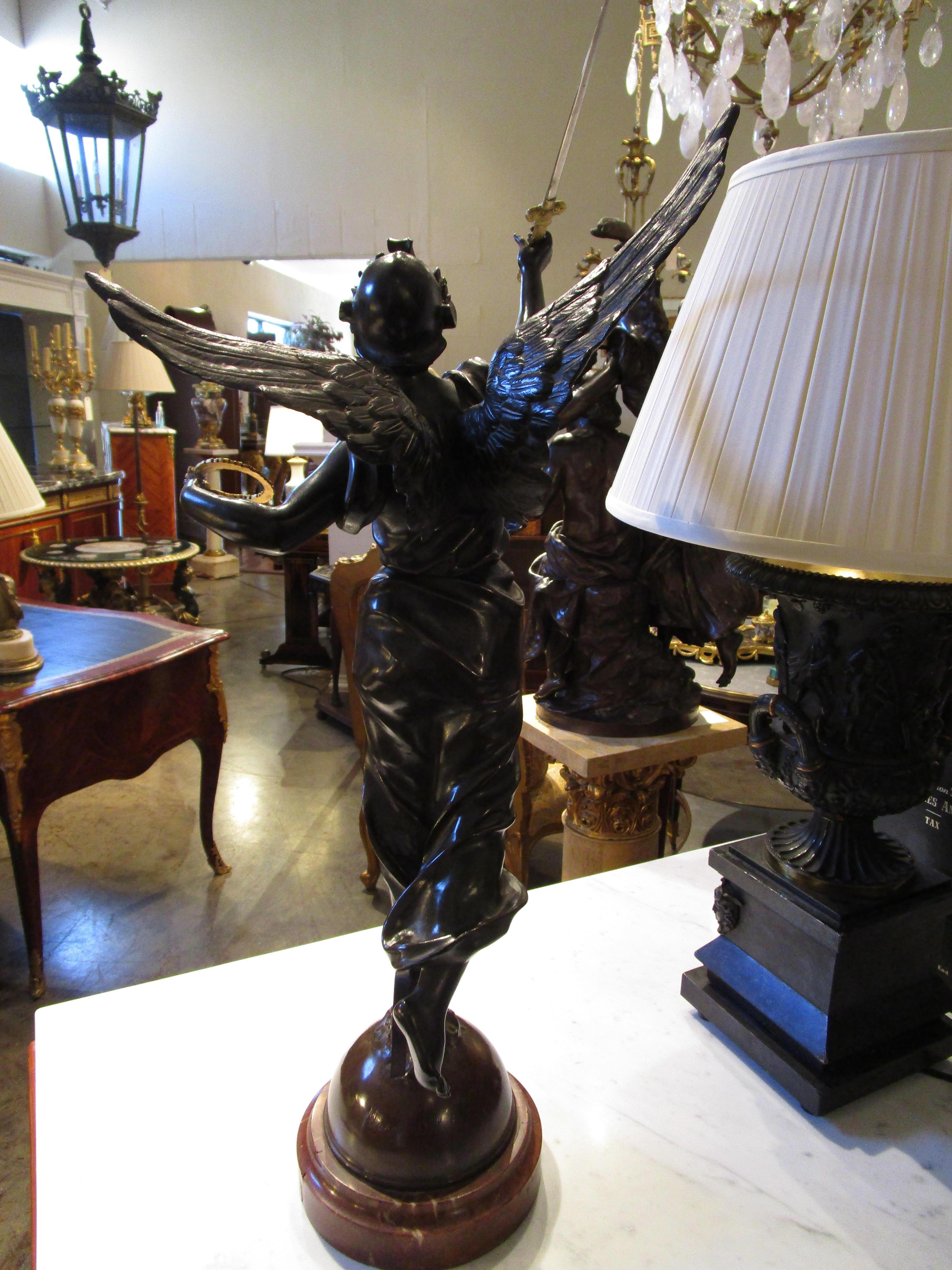 Patinated A fine 19th century French signed bronze of Victory. Parcel gilt details . For Sale