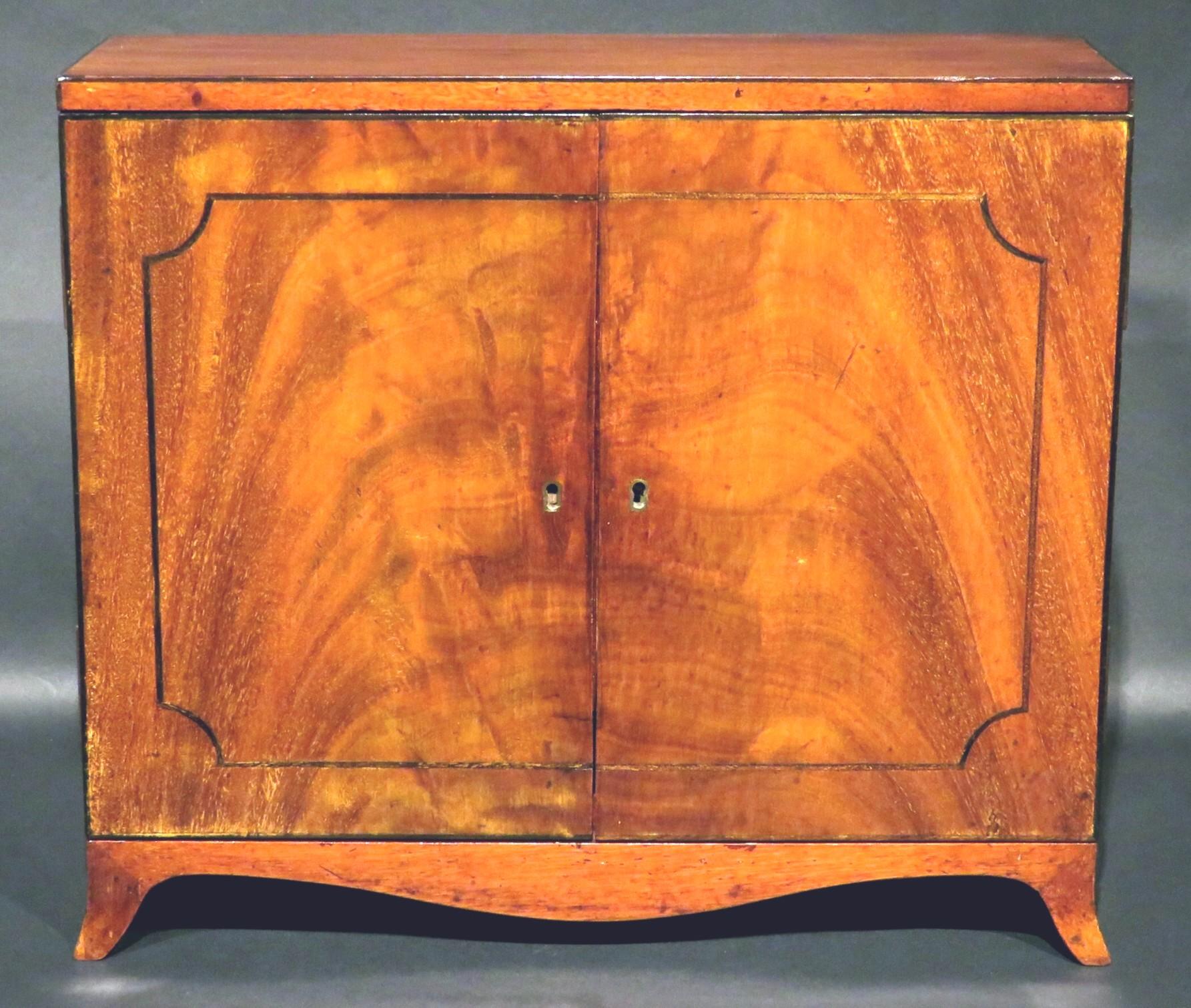 A very handsome and finely proportioned 19th century inlaid mahogany Tantalus in the form of a Georgian side cabinet, showing a richly figured & finely constructed mahogany case with an ebonized strung top & cabinet doors fitted with a functioning
