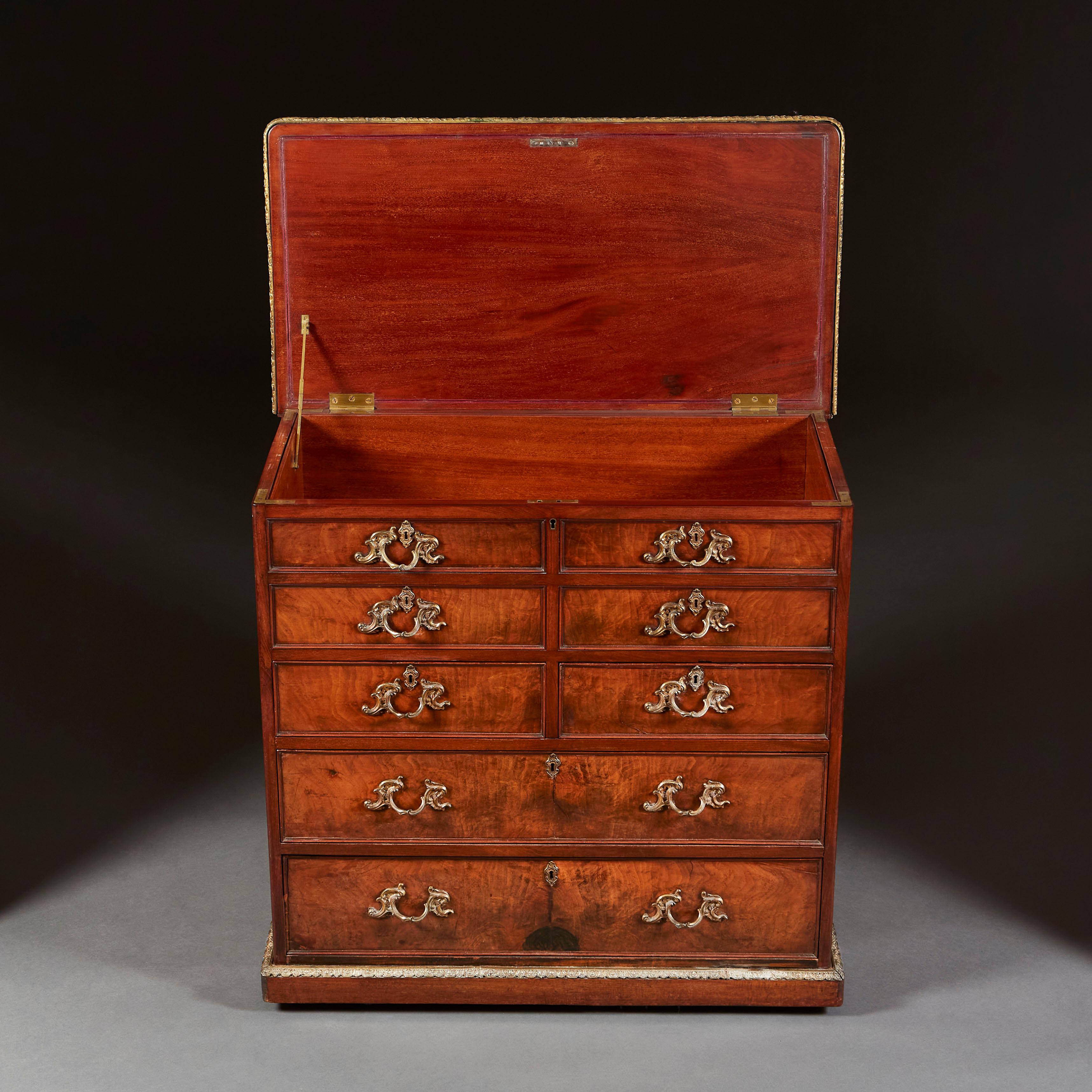 A very fine early nineteenth century mahogany chest of drawers, the top four drawers dummy with open lid, with three drawers below, the handles with fine Rococo brasswork, lined throughout with mahogany, all supported on a plinth base.