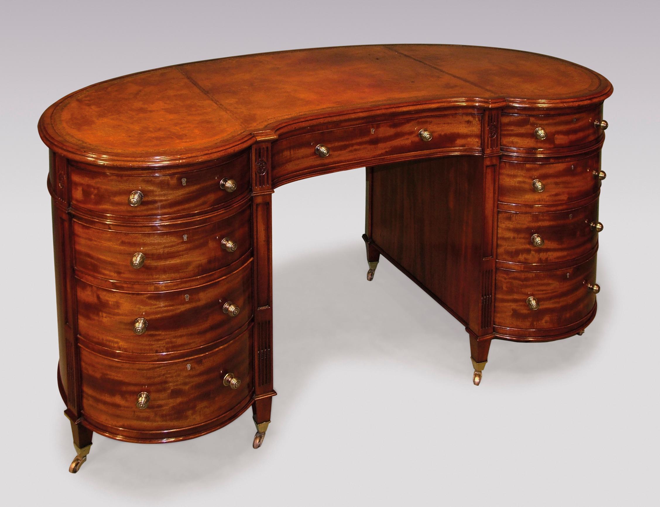 A fine quality mid-19th century well figured mahogany kidney shaped pedestal desk, having moulded edge gilt tooled leather top, above graduated drawers flanked by reeded and panelled columns with carved paterae, supported on short square tapering