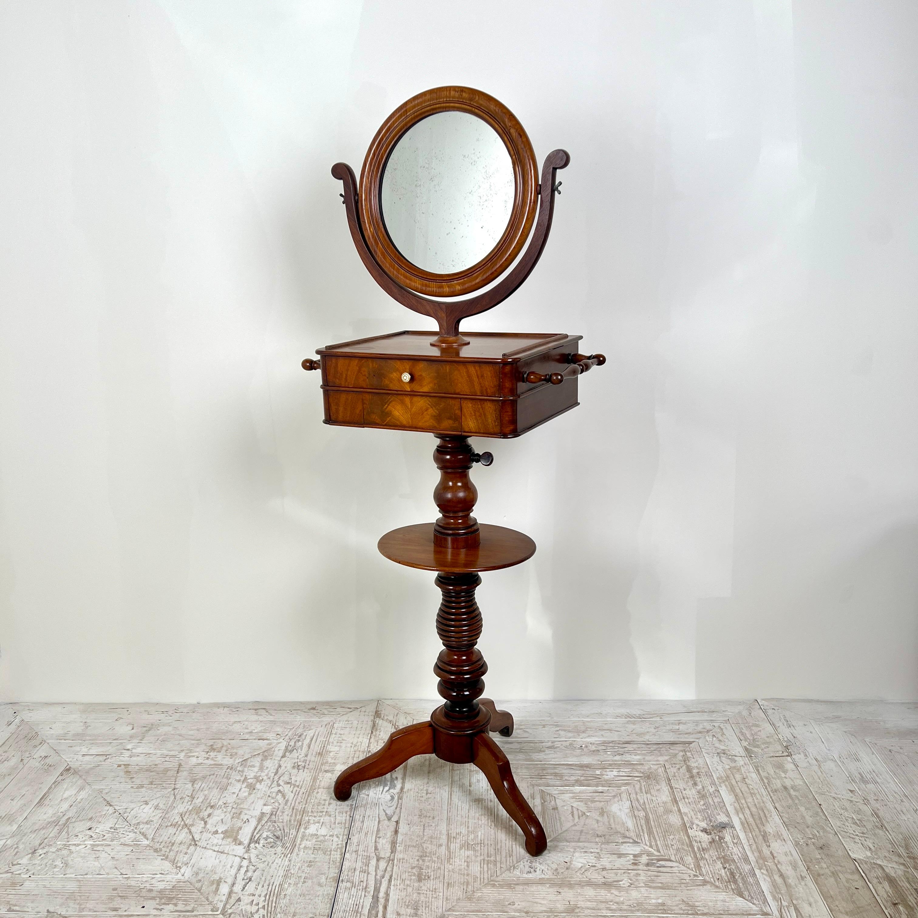 Presenting a splendid C19th Mahogany Shaving Stand. A quintessential piece that exudes the elegance and craftsmanship of its time with wonderful flame mahogany veneers to its frontage and oak drawer linings.

The stand features an adjustable mirror,