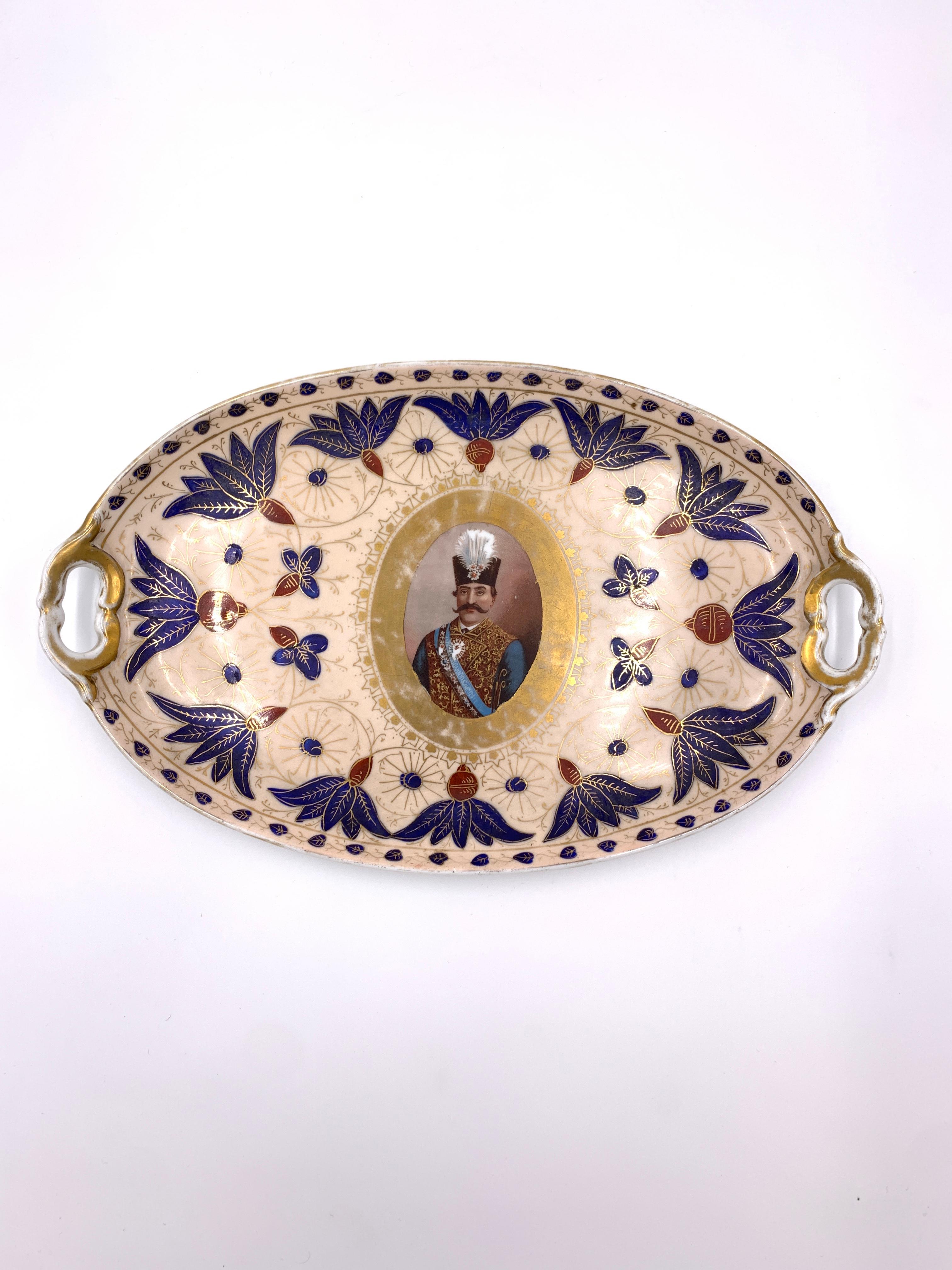 A fine 19th century porcelain tea set with medallion portrait of Eastern Potentate and blue floral enamelling. 

Dimensions: Tray: W: 35 cm, D: 22 cm, H: 3 cm 
 Tea Pot: W: 18 cm, D: 15 cm, H: 14 cm 
 Milk Jar: W: 12 cm, D: 13 cm, H: 8cm 
