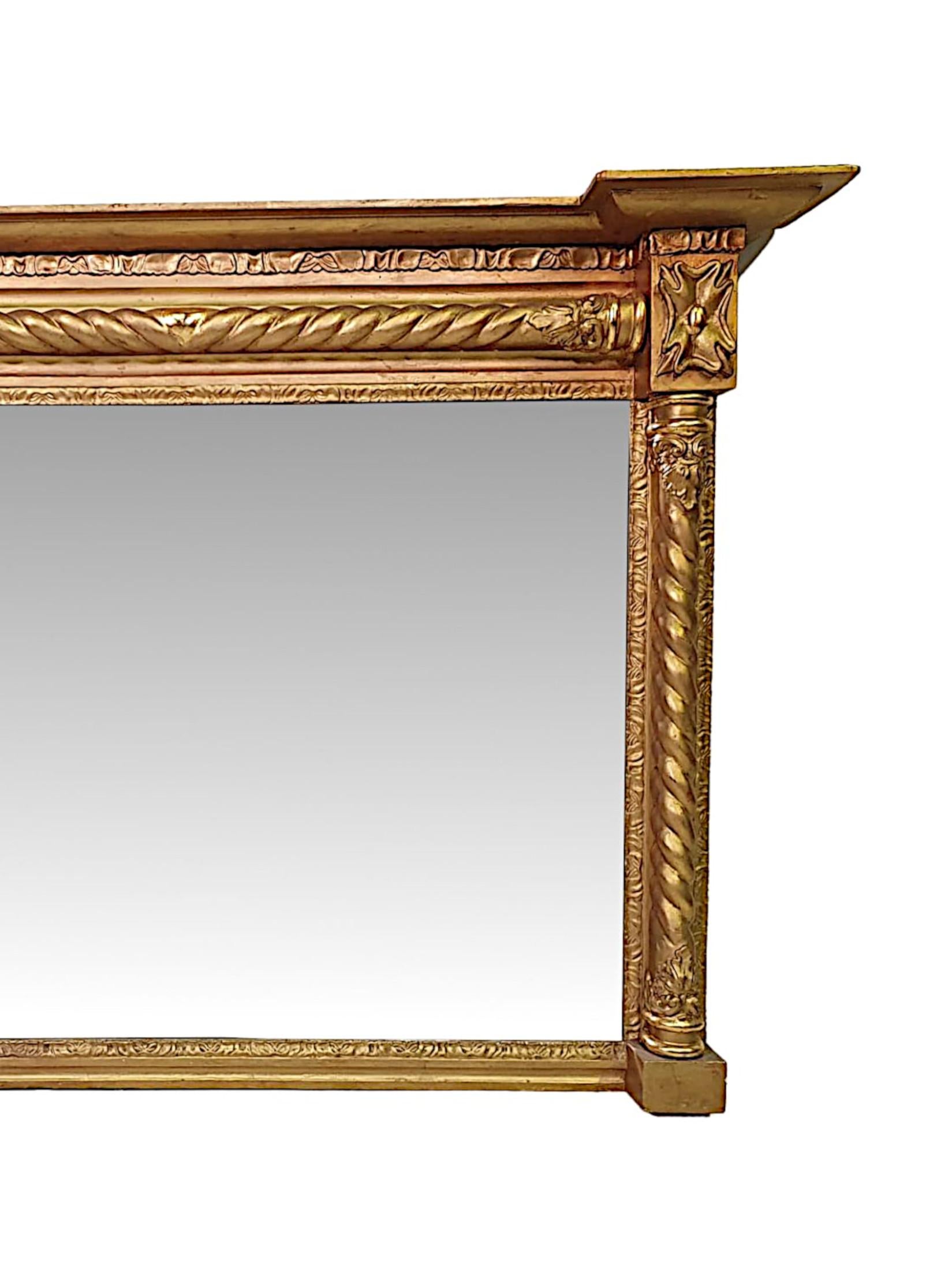 A fine 19th Century giltwood overmantle mirror of rectangular form. The bevelled mirror glass plate is set within a beautifully hand carved giltwood frame, surmounted with an overhanging broken pediment stepped cornice, raised over a spiral twist