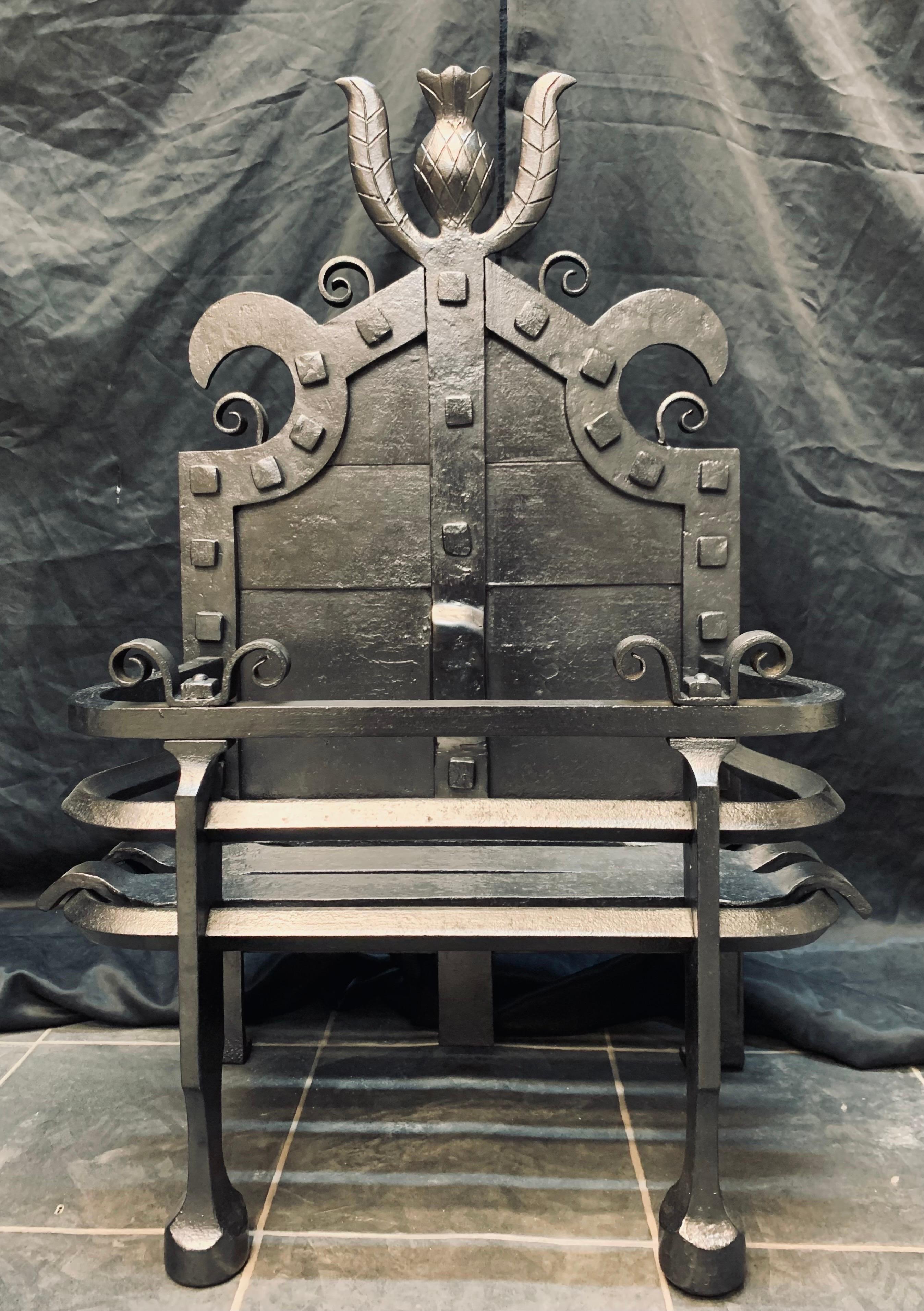 A rare late 19th century Scottish Arts & Crafts manner fire grate probably by L. Bennet Fife, Scotland. 
A high cartouche back with applied square rivets hosting a central Scottish thistle, a three barred wrought iron shaped ribbed outer frame