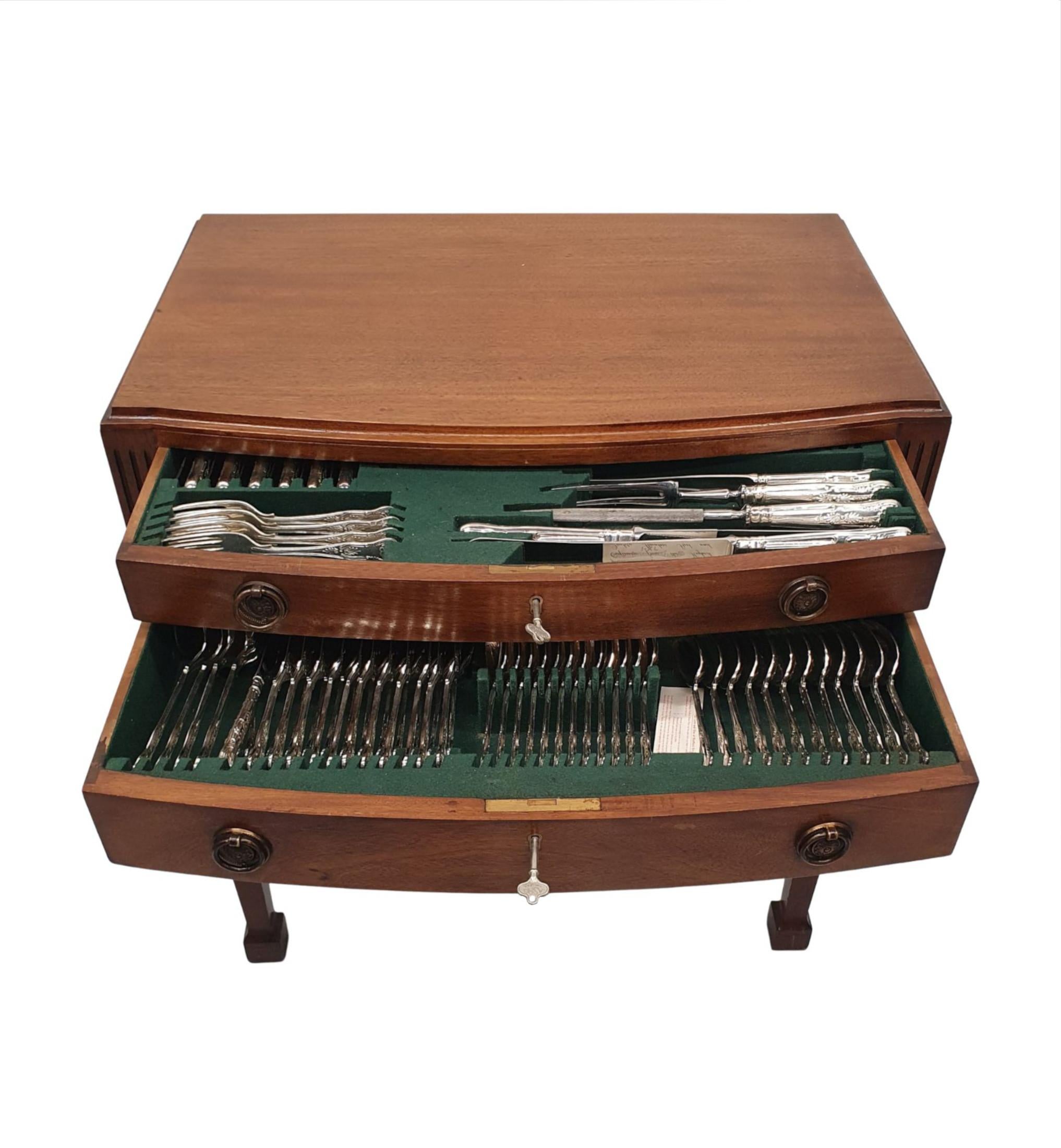 A fine 20th century mahogany fitted table canteen of Sheffield silver plate cutlery. The well figured moulded top of rectangular form with thumb moulded edge is raised over two single graduated, cockbeaded drawers with decorative brass ring pulls