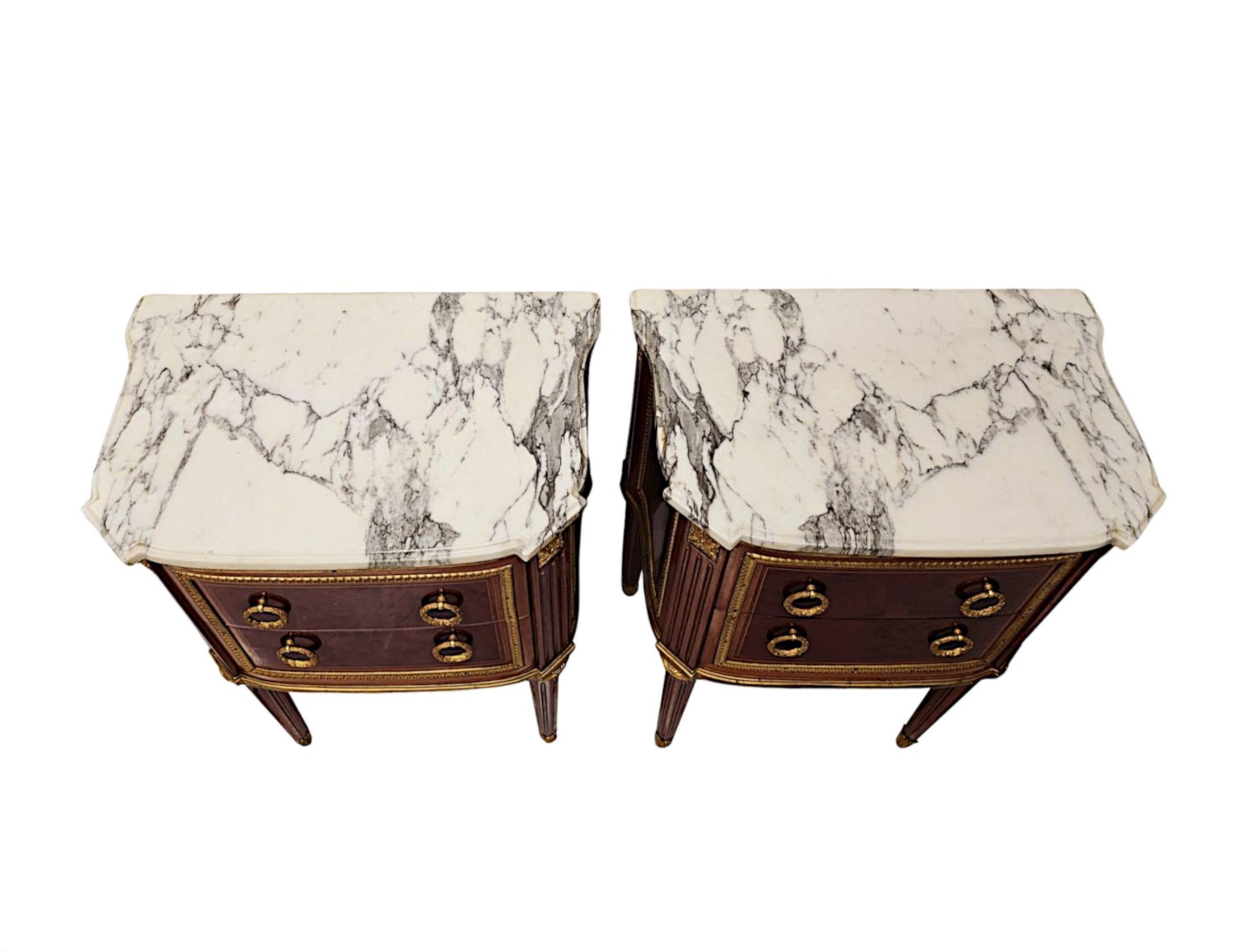 A very fine 20th Century pair of marble top finely carved pair of side tables or chest of drawers of exceptional quality, ormolu mounted throughout and with well figured timbers comprising of kingwood and mahogany with gorgeously rich patination and