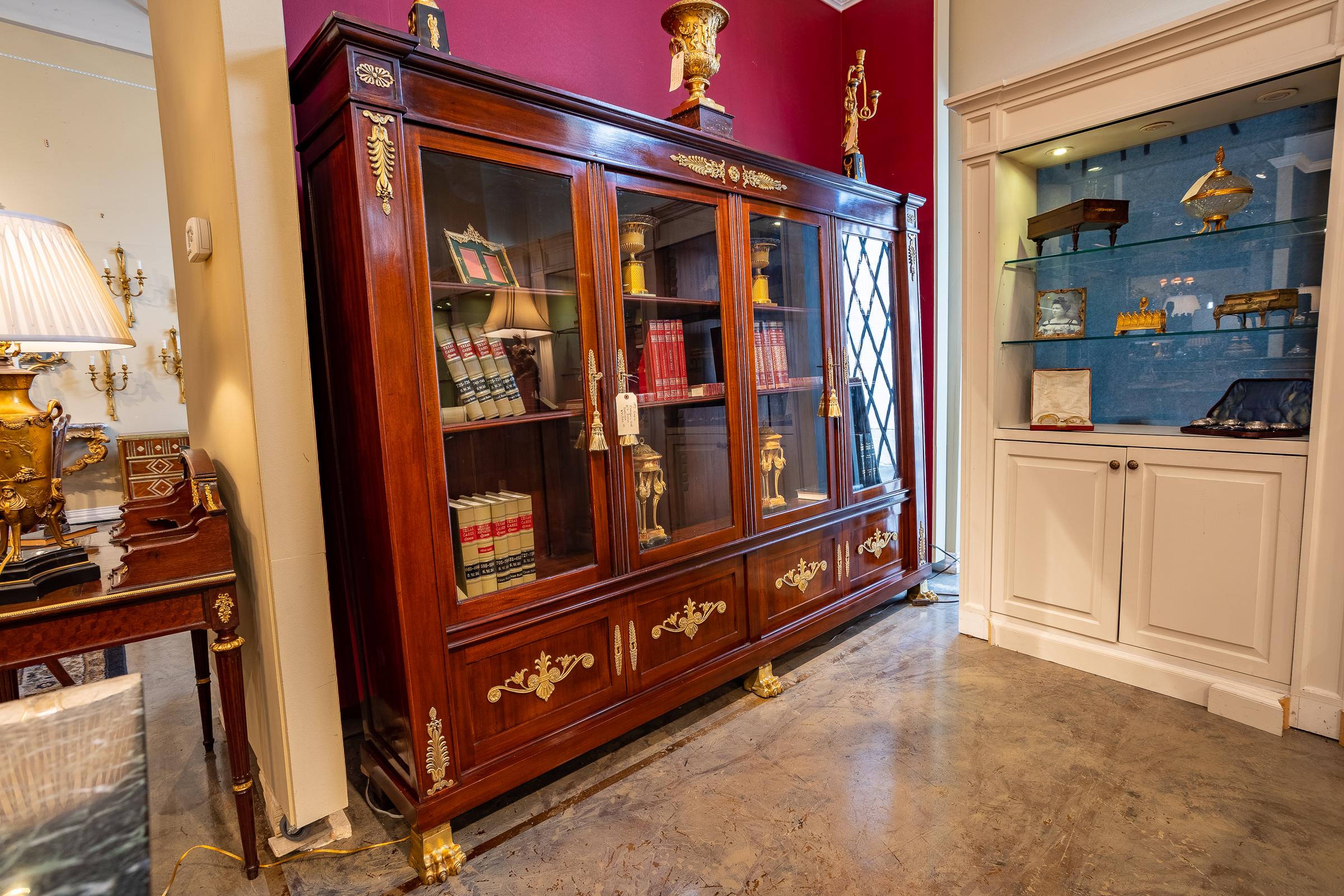 A fine and beautiful Empire mahogany and gilt bronze decorated Empire library viewing cabinet. All original with fine gilt bronze pawed feet. Adjustable shelves, hand pegged.