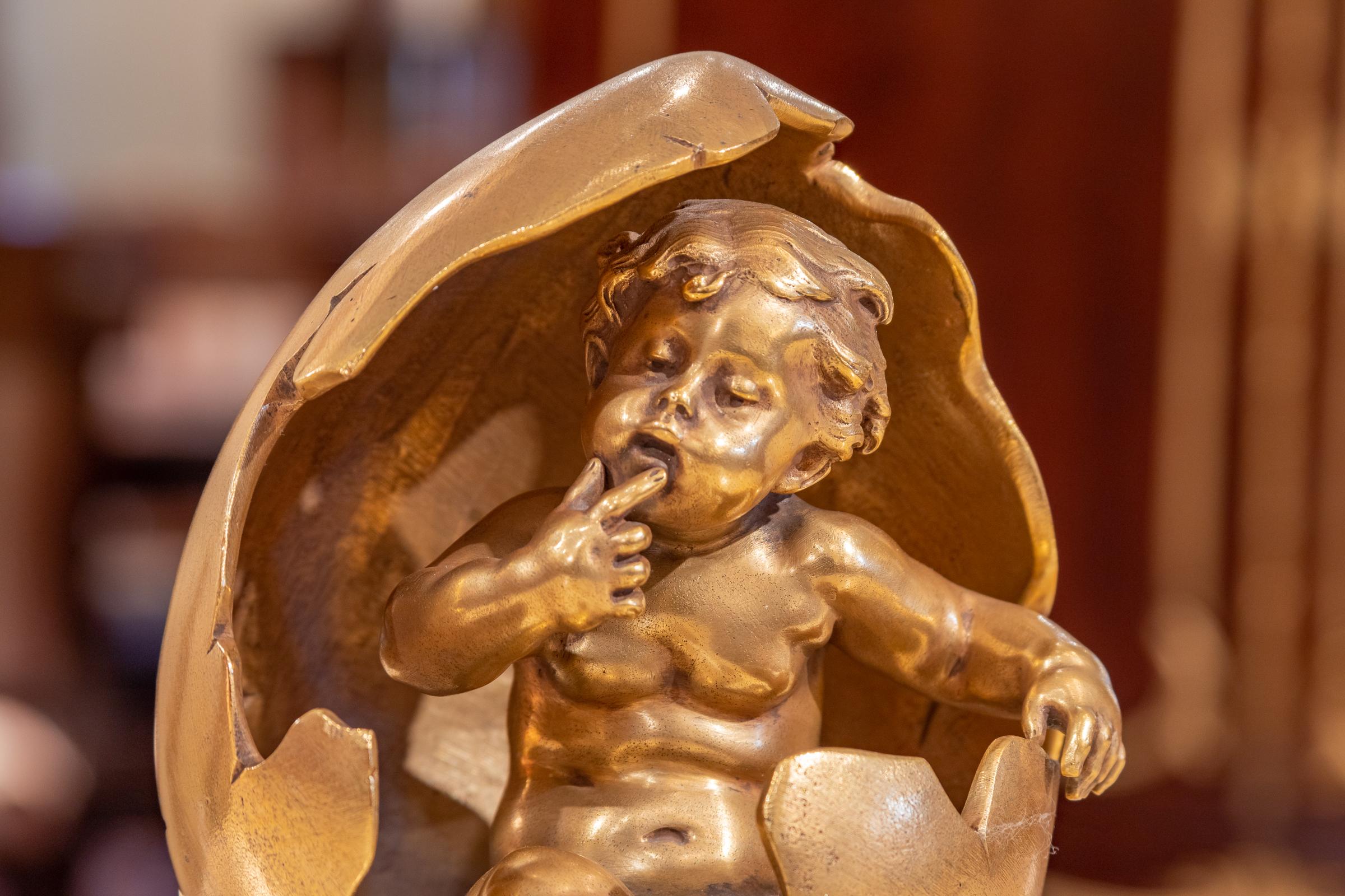 A very fine and rare 19th century decorative figure of a cherub coming out of an egg in gilt bronze by August Moreau