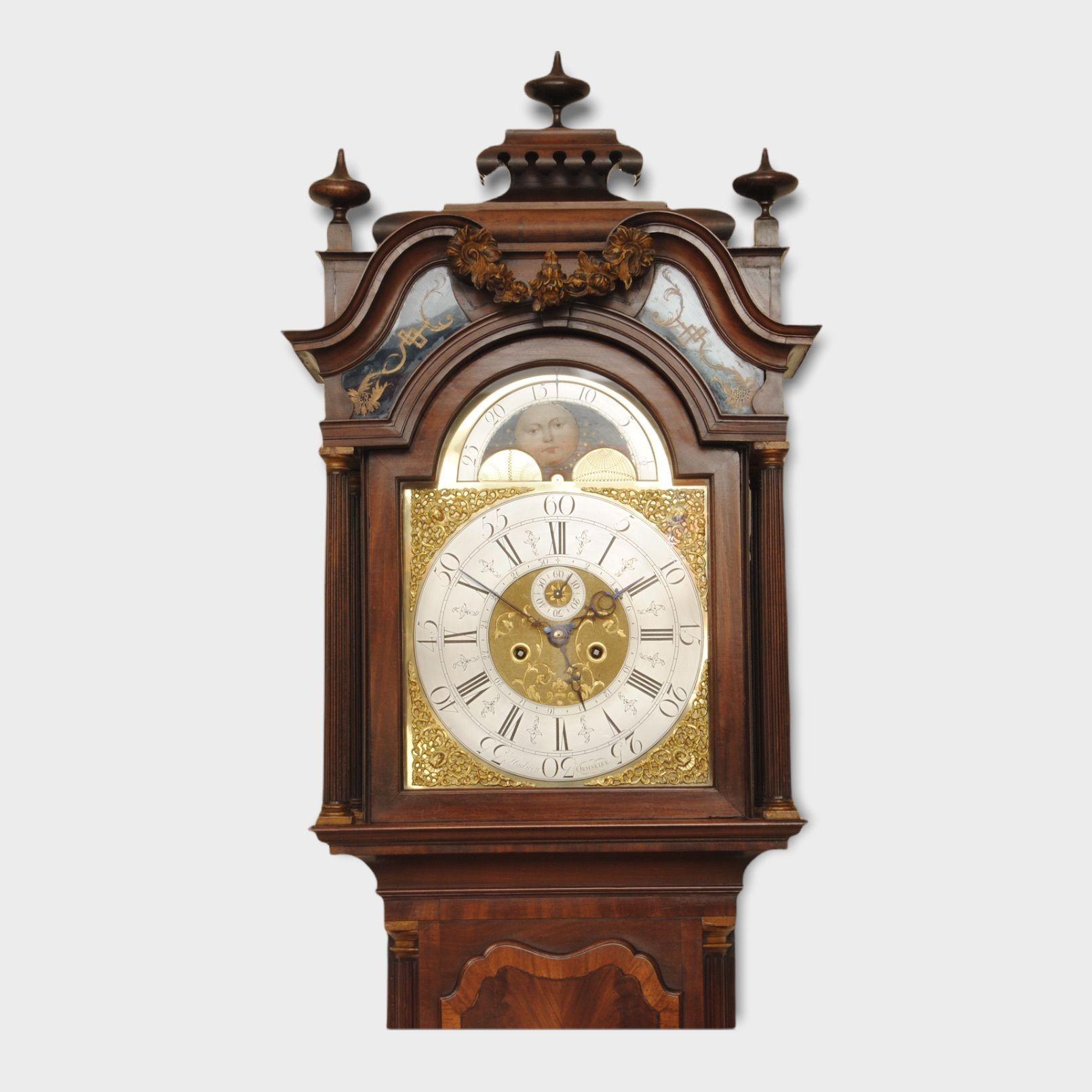 A fine example of an eight day longcase clock with wonderful full brass dial, moon roller and date hand. The superb mahogany case has a cross banded door veneered in flame mahogany with reeded columns to the sides, the base also has a cross banded