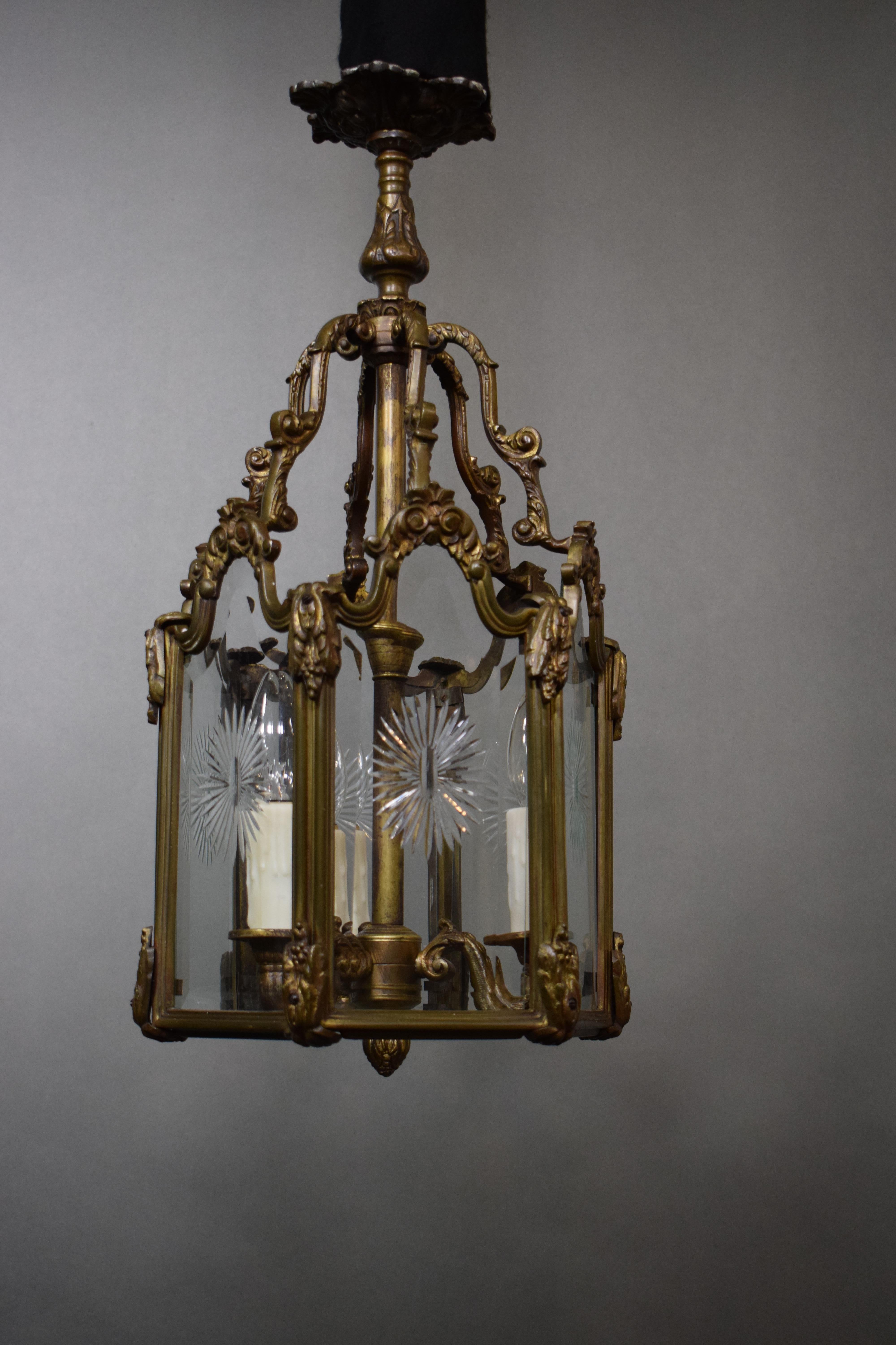A fine and elegant bronze hexagonal lantern featuring handcut glass panels, France, circa 1920. 3 lights.
Dimensions: Height 24