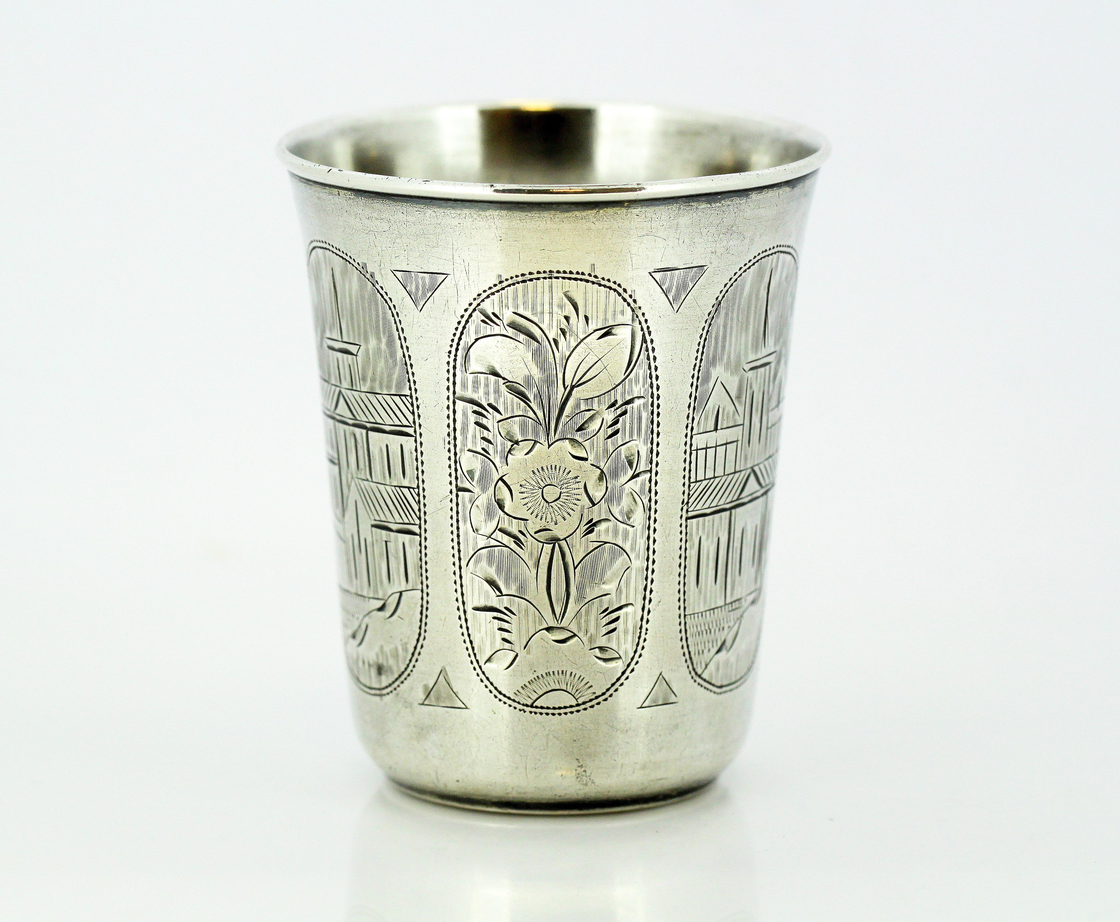 A fine and impressive antique Russian silver Kiddush cup.

The surface of the silver beaker is embellished with fine and impressive engraved decoration depicting a simplified archway revealing alternating leaf motif and city scenes.

Maker: ???