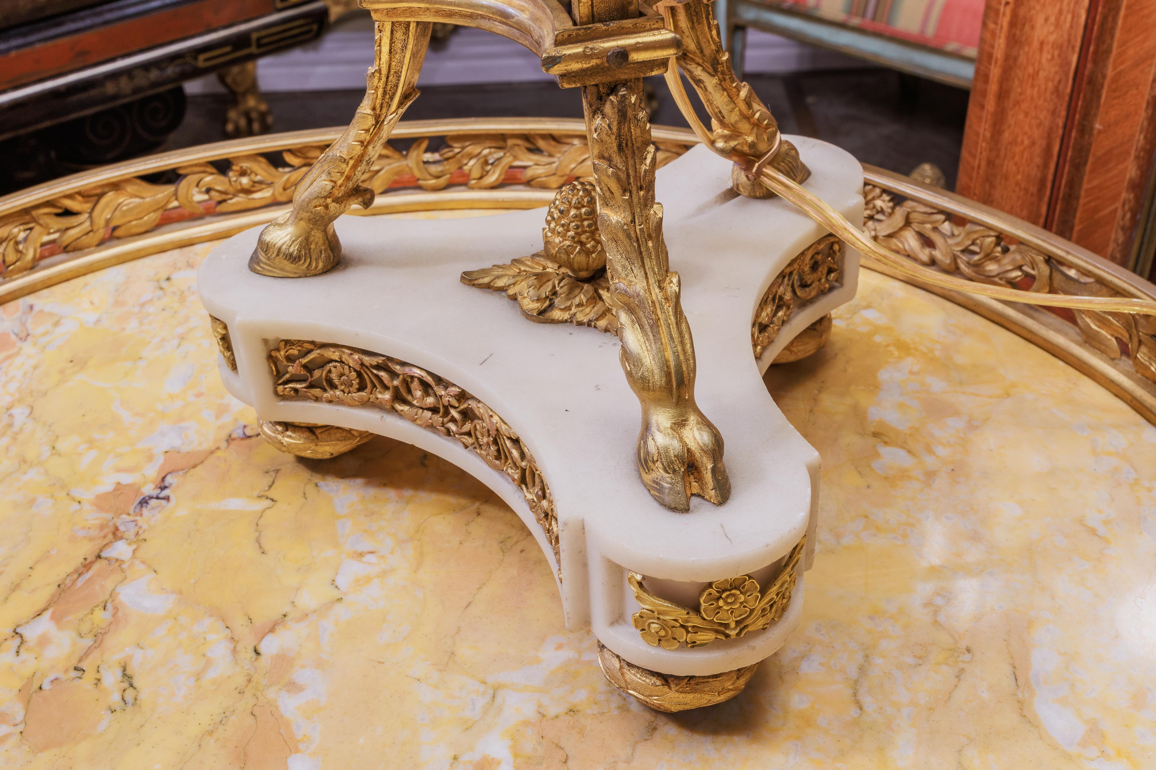 A very fine and large 19th century French Louis XVI Carrera marble and gilt bronze mounted tripod lamp. 