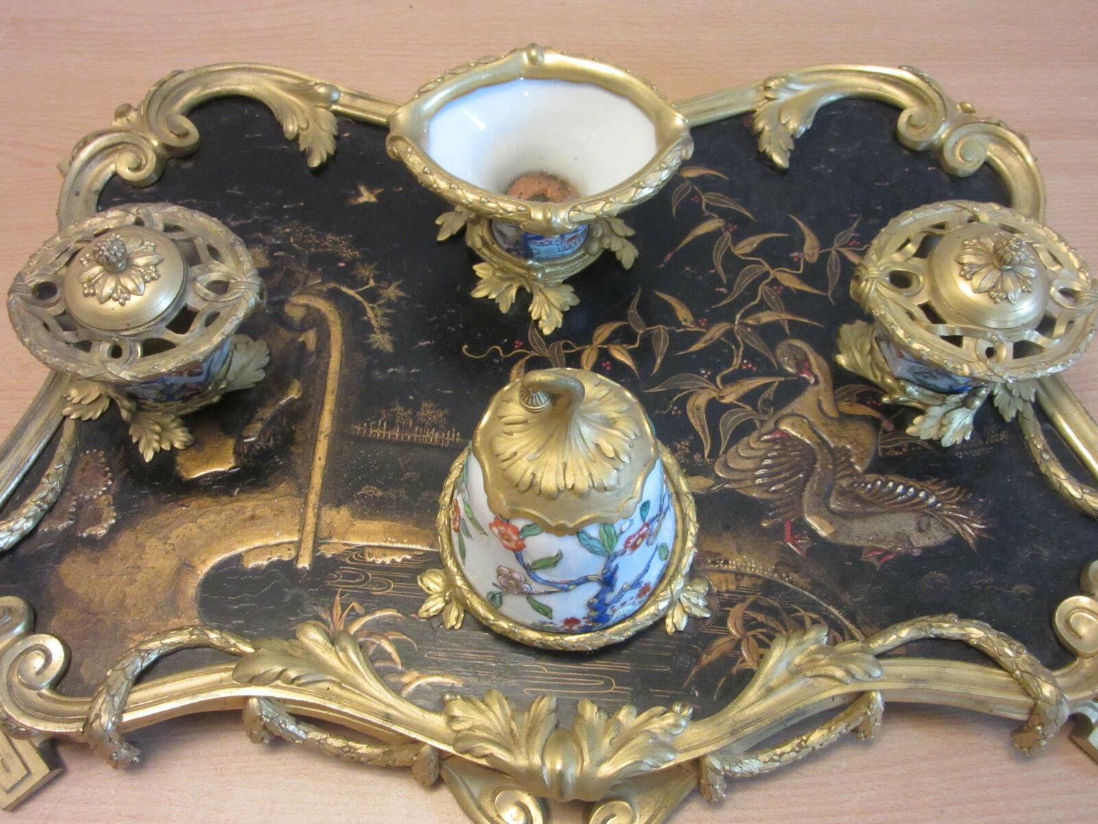 A fine and large 19th century Chinoiserie inkwell with raised decoration and fine gilt bronze mounts. Porcelain inkpots and a porcelain bell.