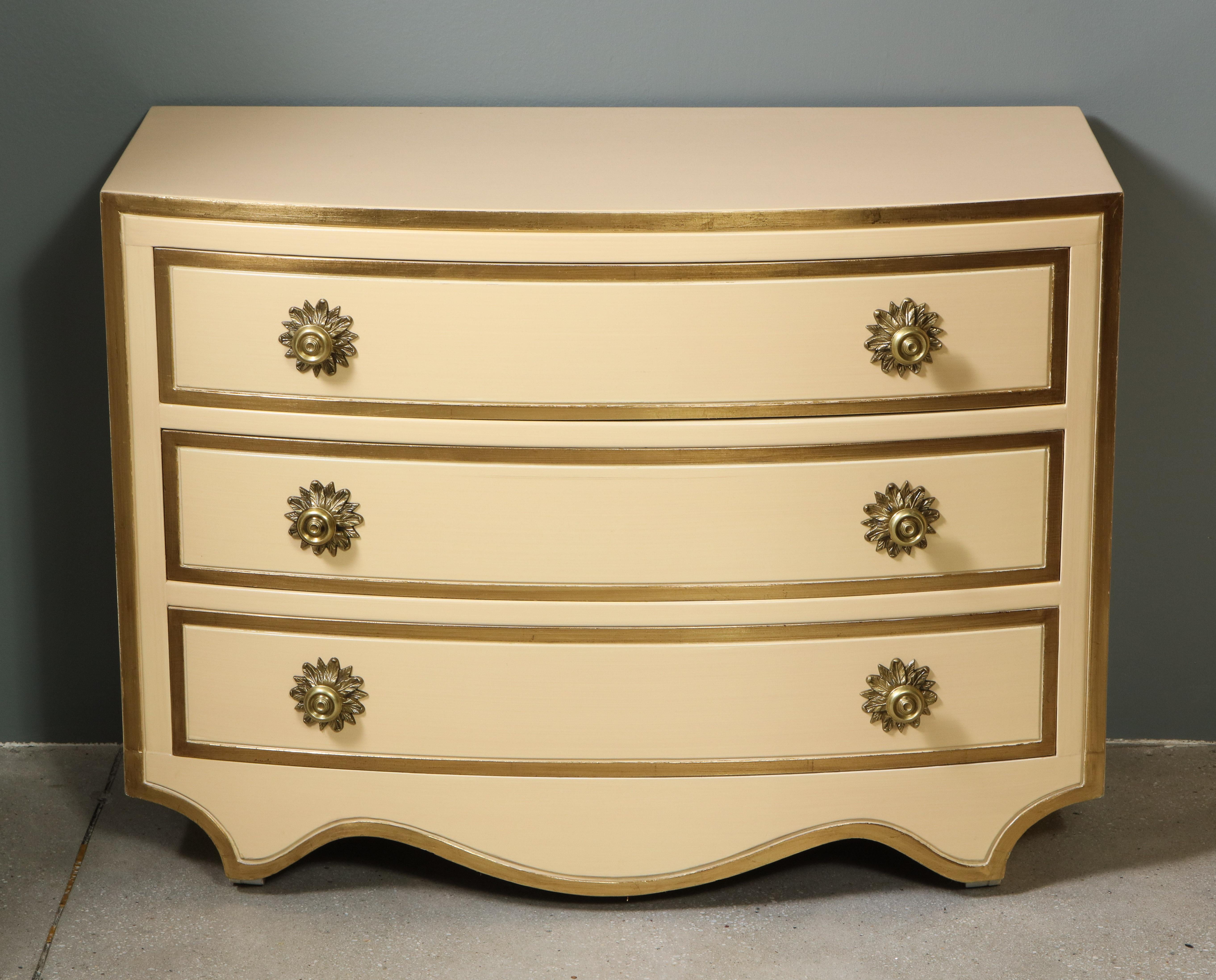 The painted and parcel gilt chests, having brass pulls with acanthus leaf motif back plates. The bow-front profile with three drawers over legs cut into a curvilinear design. The scale allows for bedside or side table use. Recently restored and in