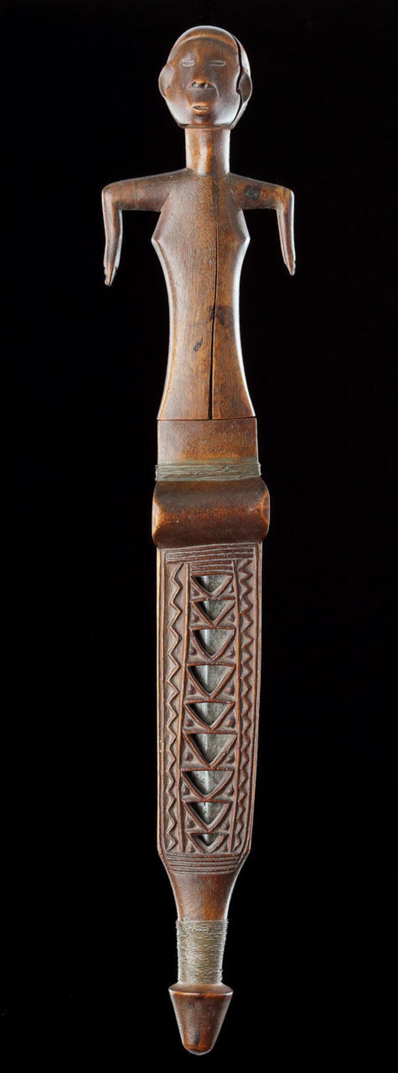 A Fine and Rare Shona Knife and Sheath 

Wood, steel, copper 

Fine colour and patina 

Zimabawe / Africa



19th Century 



Size: 48cm long - 19 ins long (with scabbard) 

42.5cm long, 9cm wide - 16¾ ins long, 3½ ins wide (without) 



Provenance: