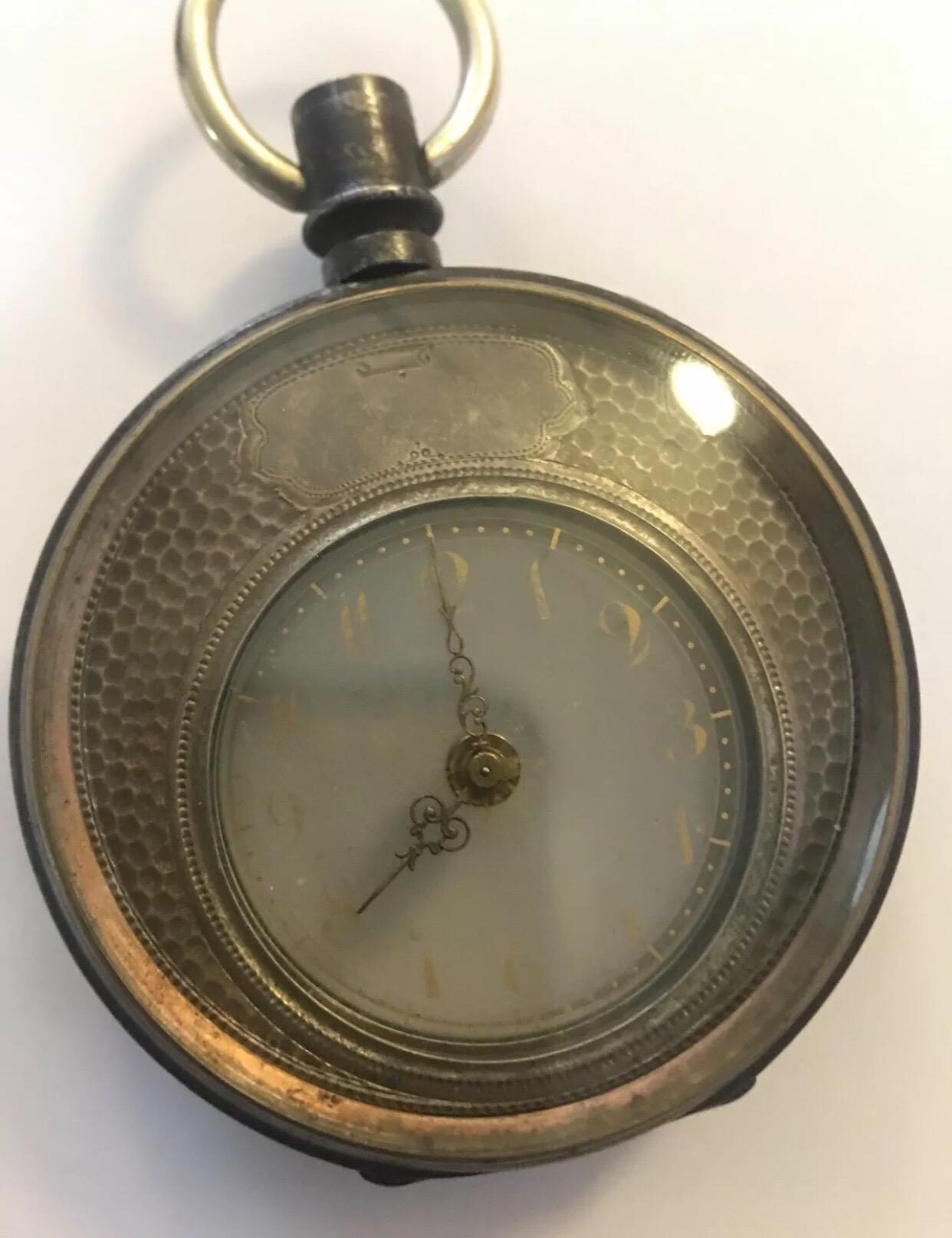 Here we a have a very fine and rare vintage Swiss solid silver late 19th century mystery pocket watch. The watch has a transparent glass dial with applied gilt Arabic numerals.  Keyless wind crescent shaped movement hidden under the silver guilloche