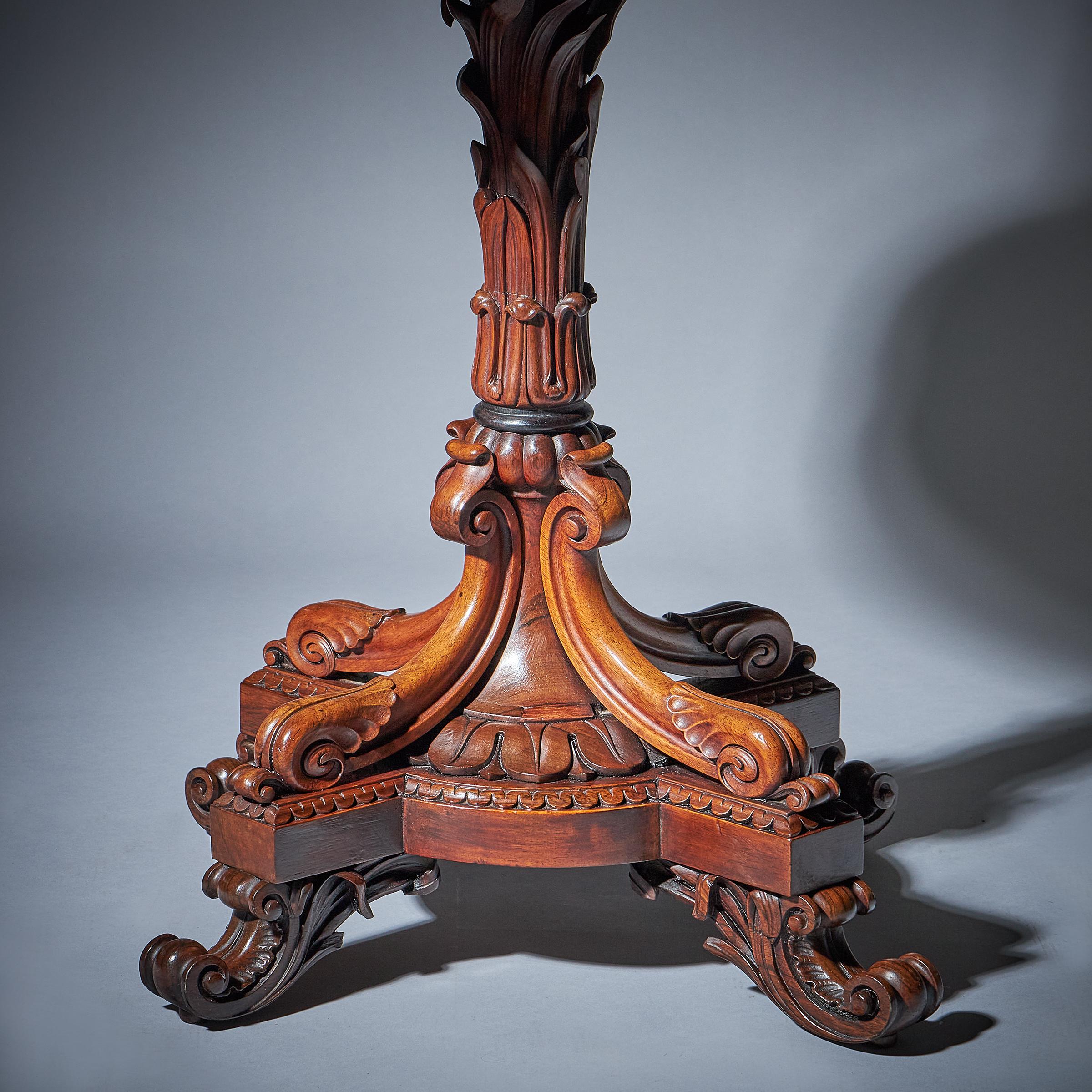 The stepped two-stage upper part with recessed shelving and leather spine triple book divisions beneath the original tooled leather top. The elaborately carved base with quadruple leafing scrollwork supports and branching stem on a circular base