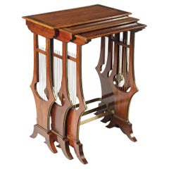 A fine and unusual nest of three Regency tables