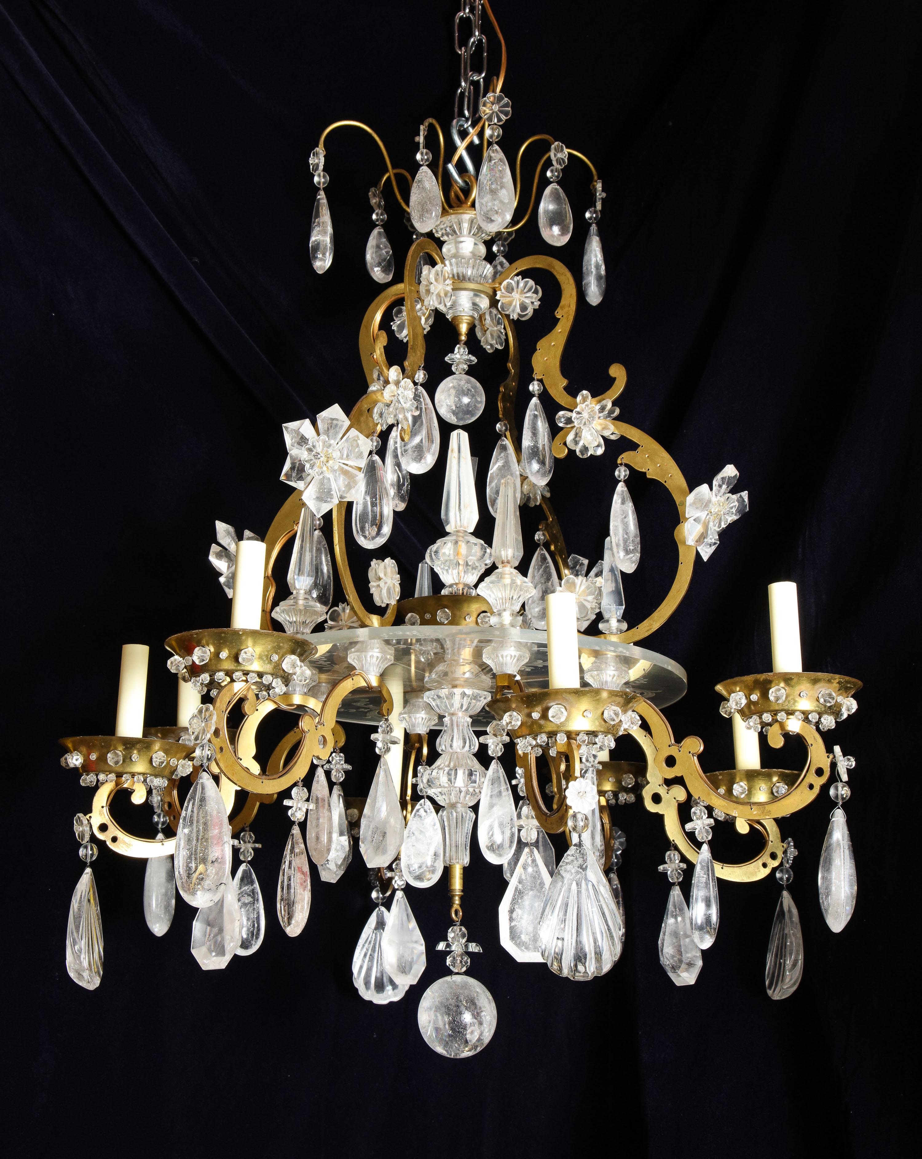A fine and unusual antique French Louis XVI style gilt bronze. Cut rock crystal and Lucite multi light chandelier of superb workmanship embellished with a central engraved Lucite flat dish and further adorned with cut rock crystal prisms and flowers